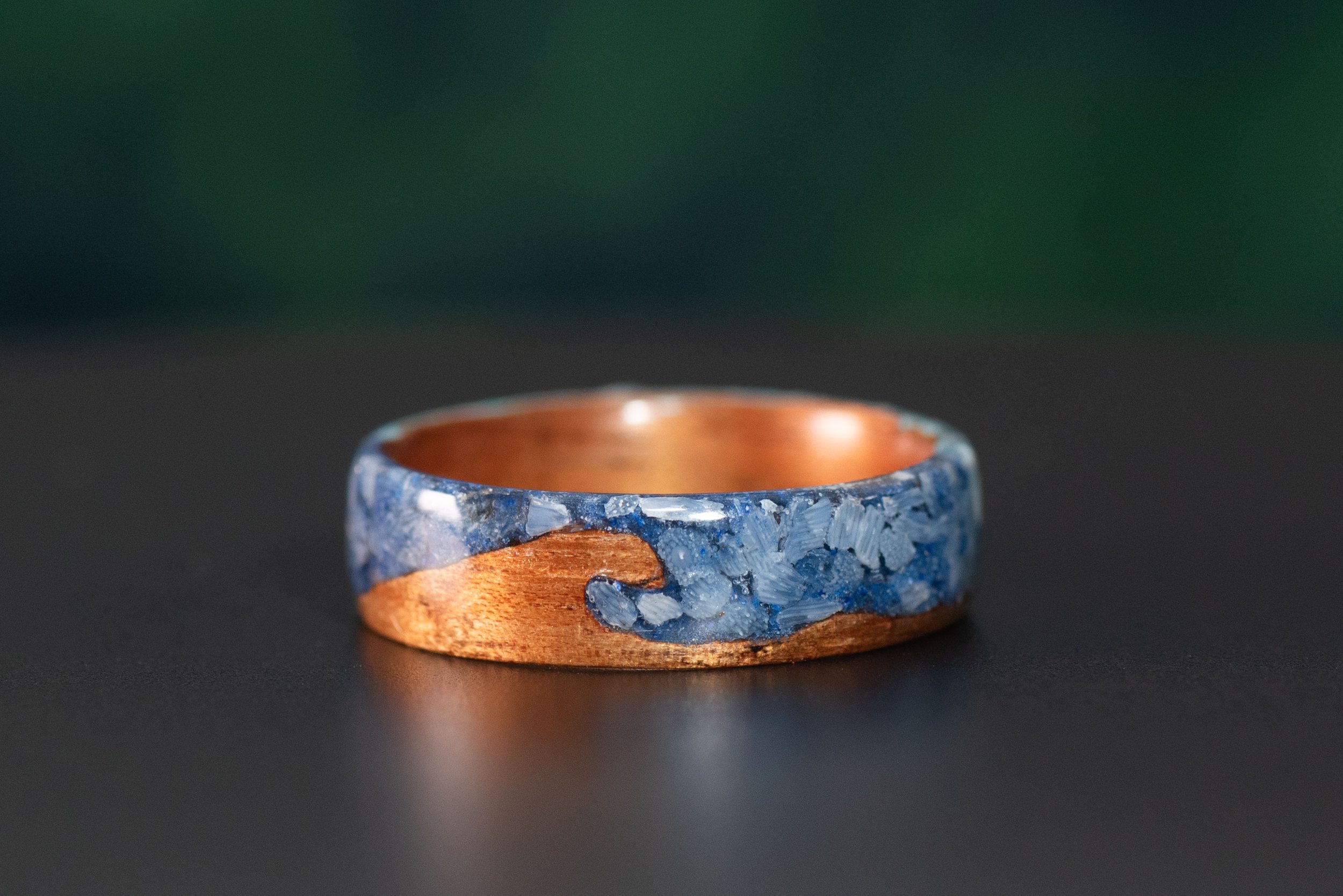 Koa wave ring with blue coral and lapis lazuli sky inlay and customizable ring core.