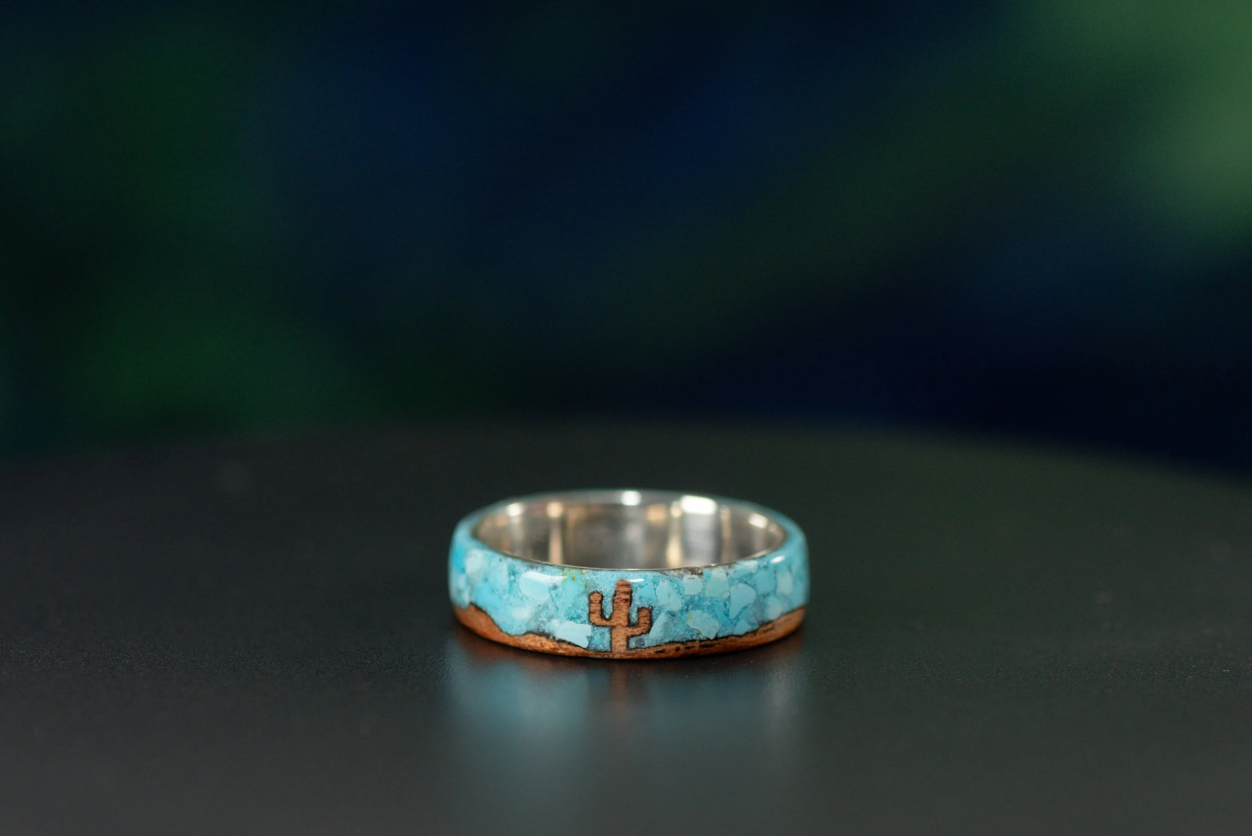 Cedar wood ring with cactus design, Sleeping Beauty turquoise sky inlay and sterling silver core.