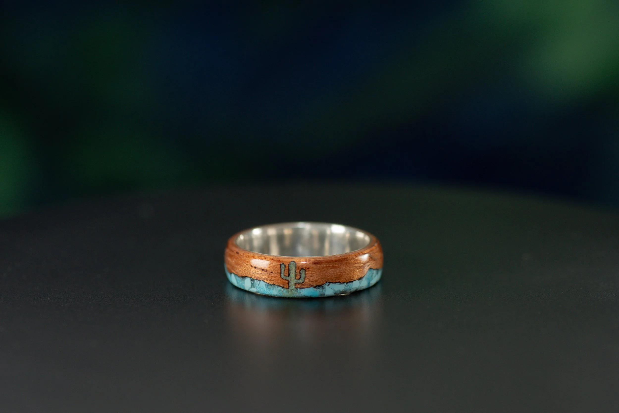 Cedar wood ring with sterling silver core and green Sonoran turquoise cactus and mountain inlay.