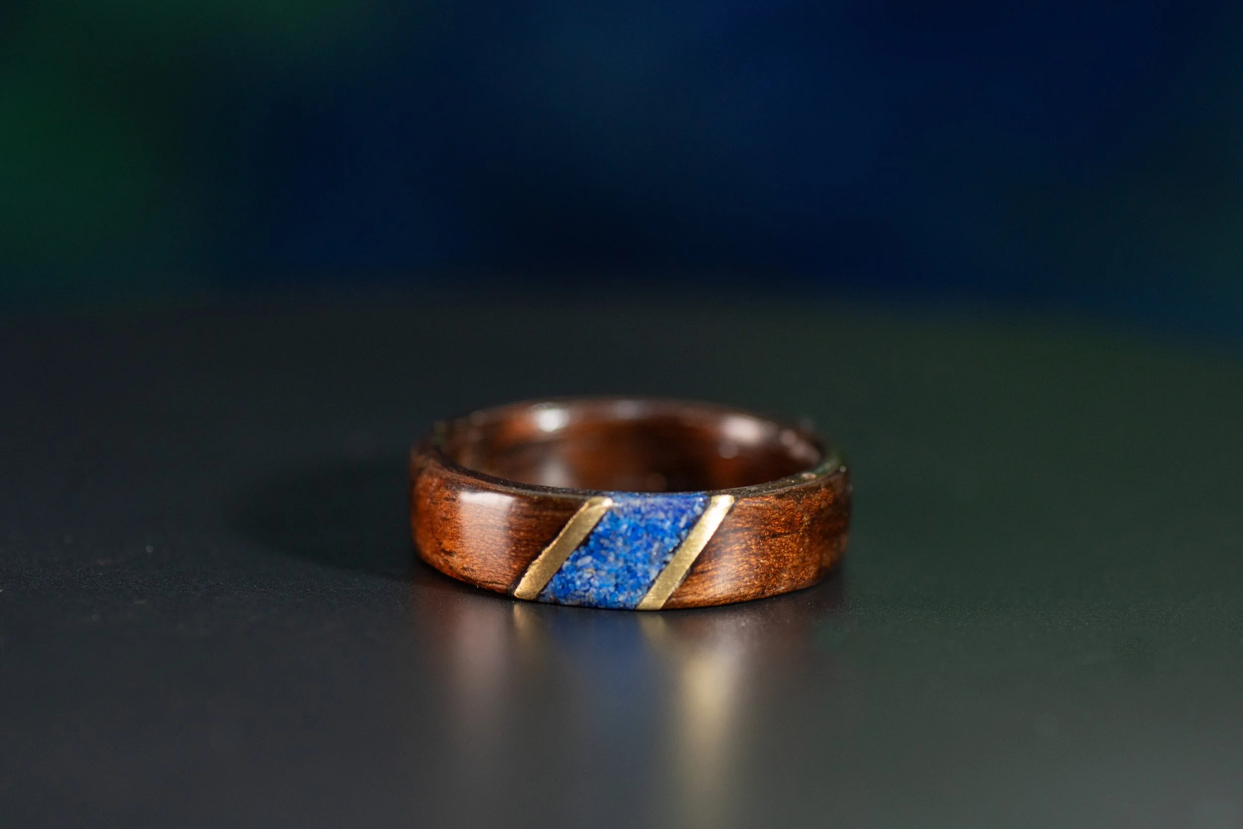 Custom smoked rosewood ring with outlined blue stone inlay