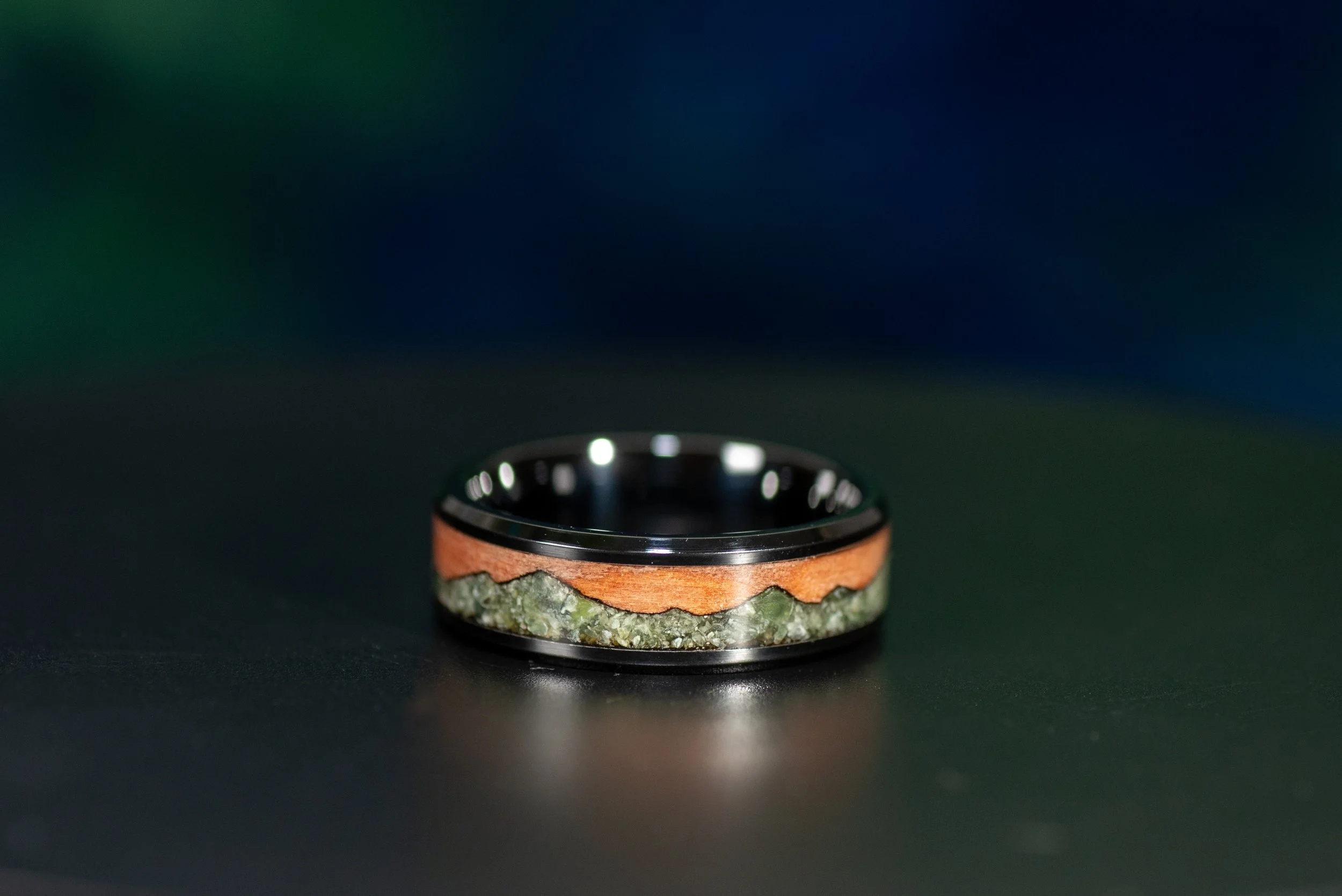 Handmade outdoor inspired ring with black ceramic, tineo wood and green jade mountain inlay.