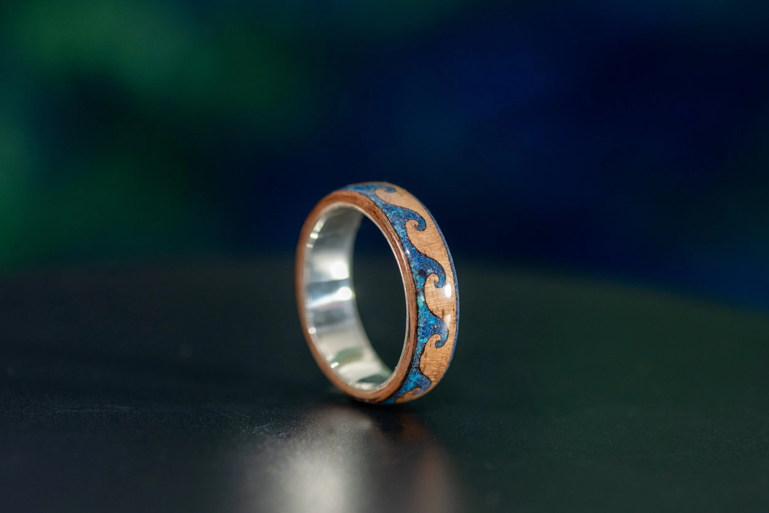 Handmade coastal wedding band with walnut wood, lapis lazuli, shattuckite and customizable ring core.