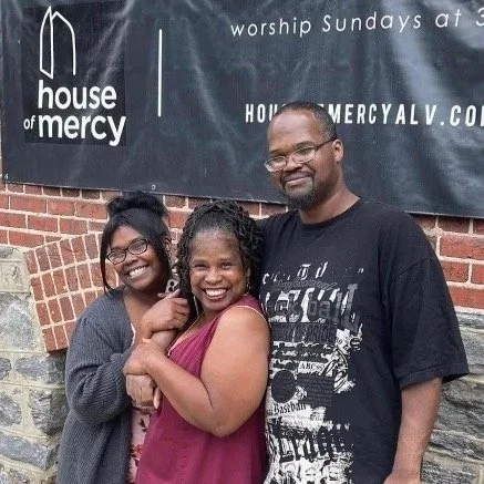 House of Mercy congregation members celebrating together outside the church