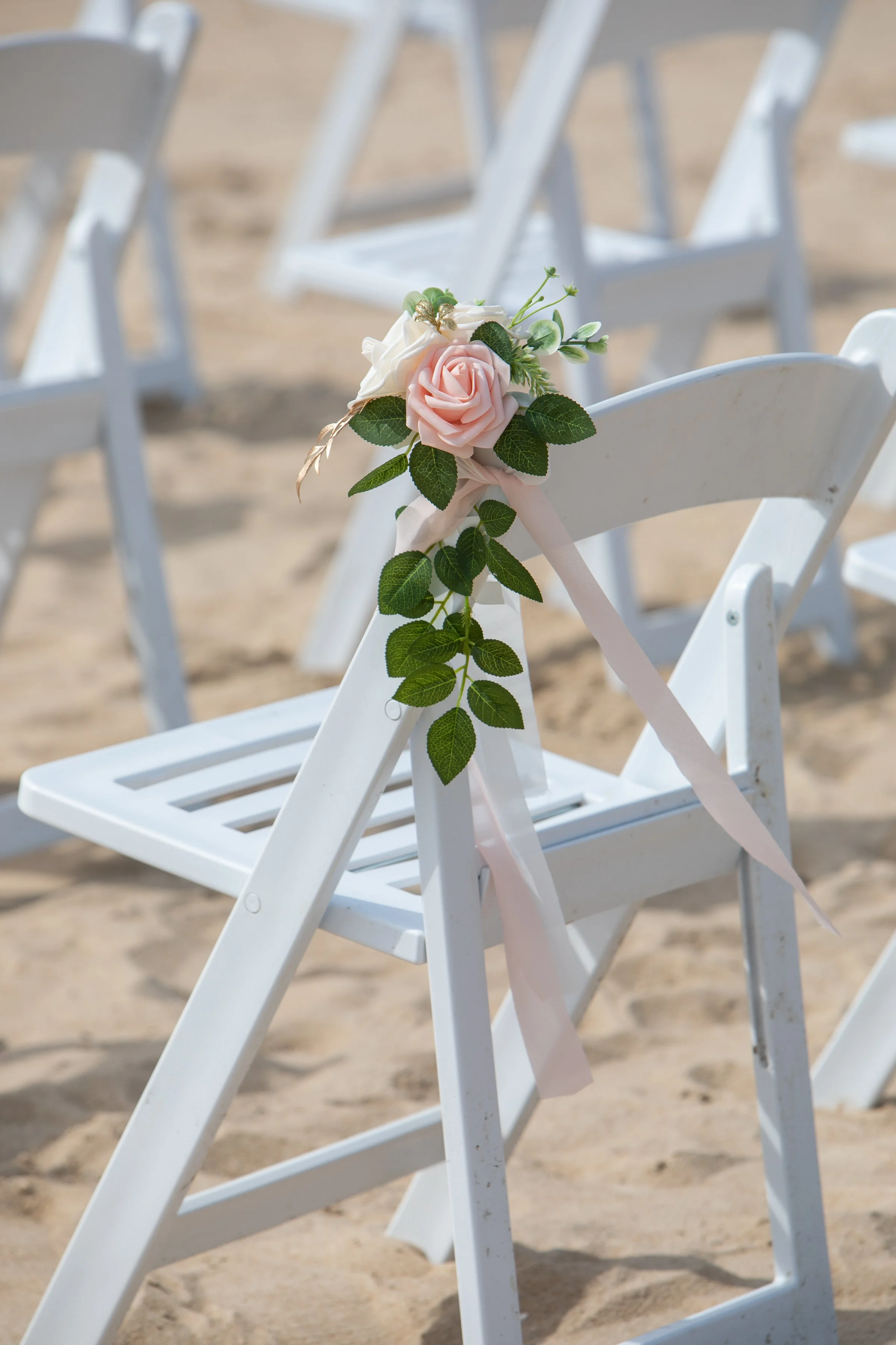 White folding chairs for beach weddings