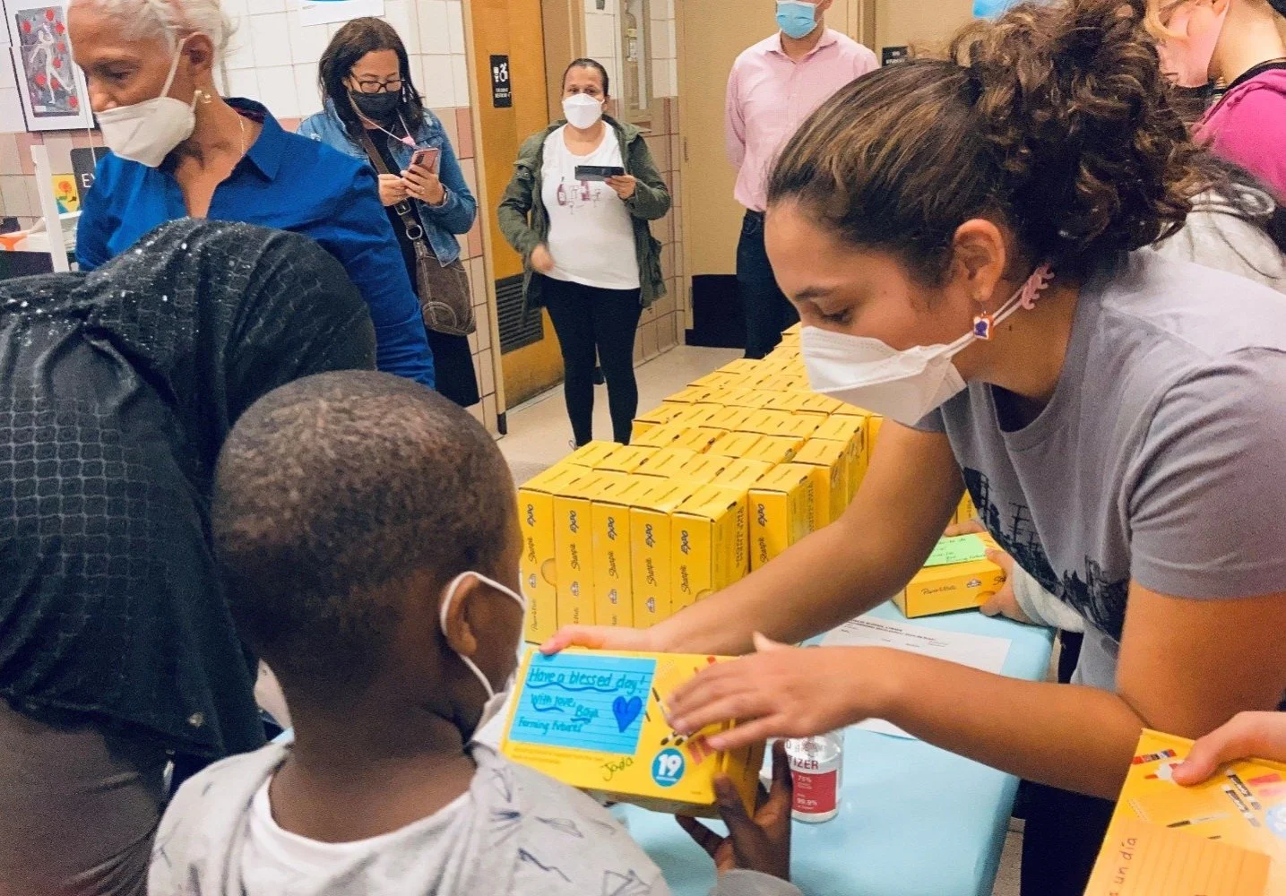 Victoria donating supplies to child
