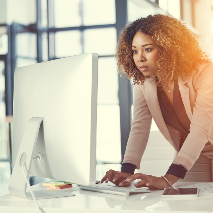 Woman looking intently at a computer screen.
