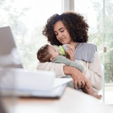 woman bottle feeding a baby