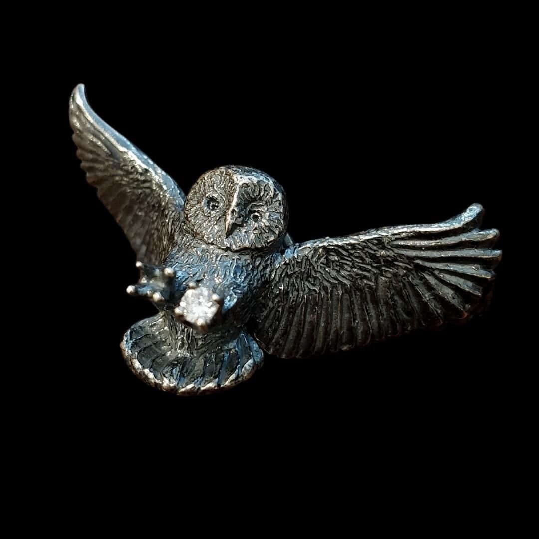 I've always felt drawn to depicting owls in motion, reaching for prey or place to land, rather than perched on a branch. That dynamic motion of the talons reaching forward, their wings sweeping back, and eyes locked on their target. 
Other than the b
