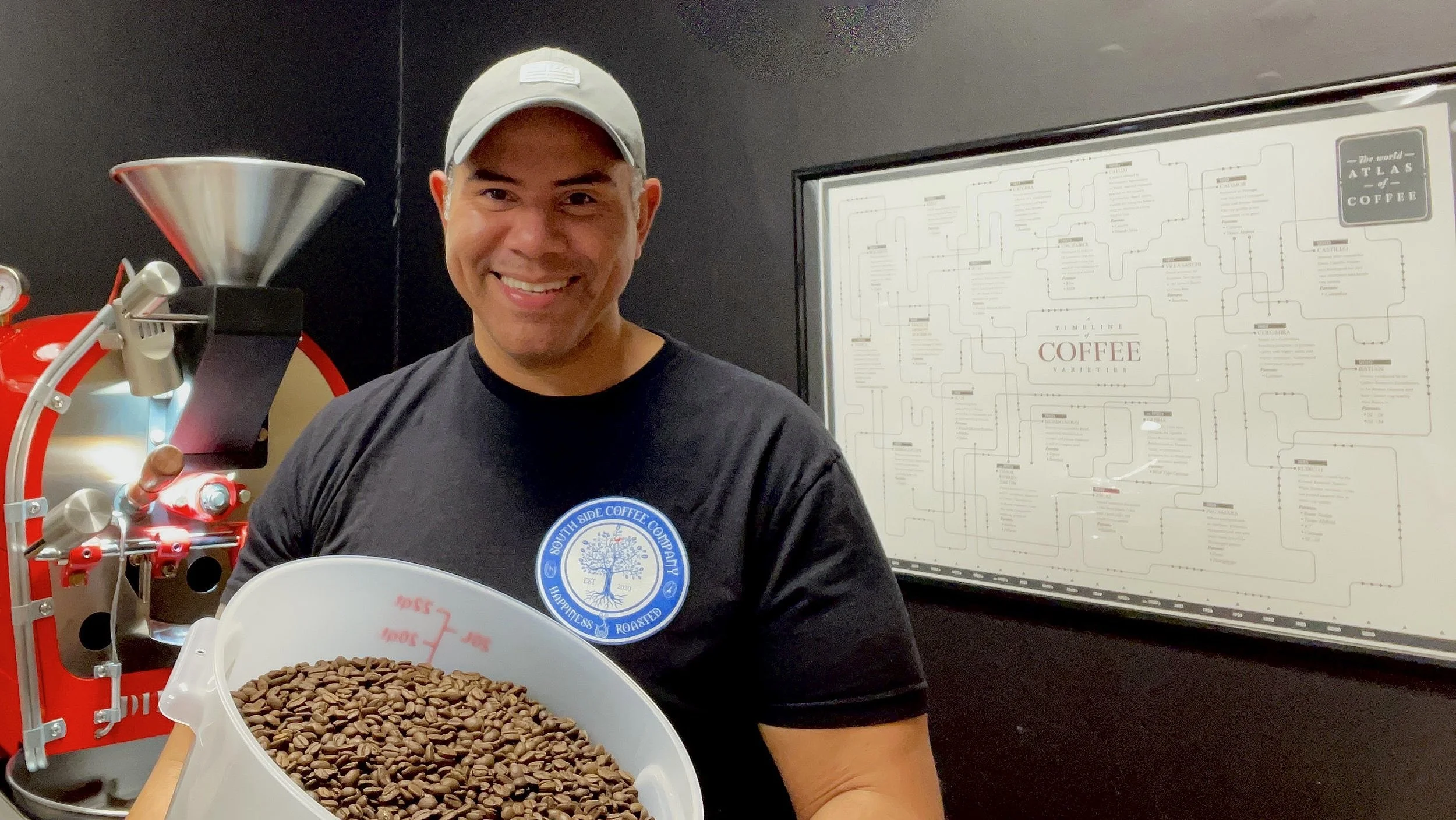 Mark from Southside Coffee Co holding freshly roasted coffee in front of a Diedrich roaster in Scotch Plains, New Jersey