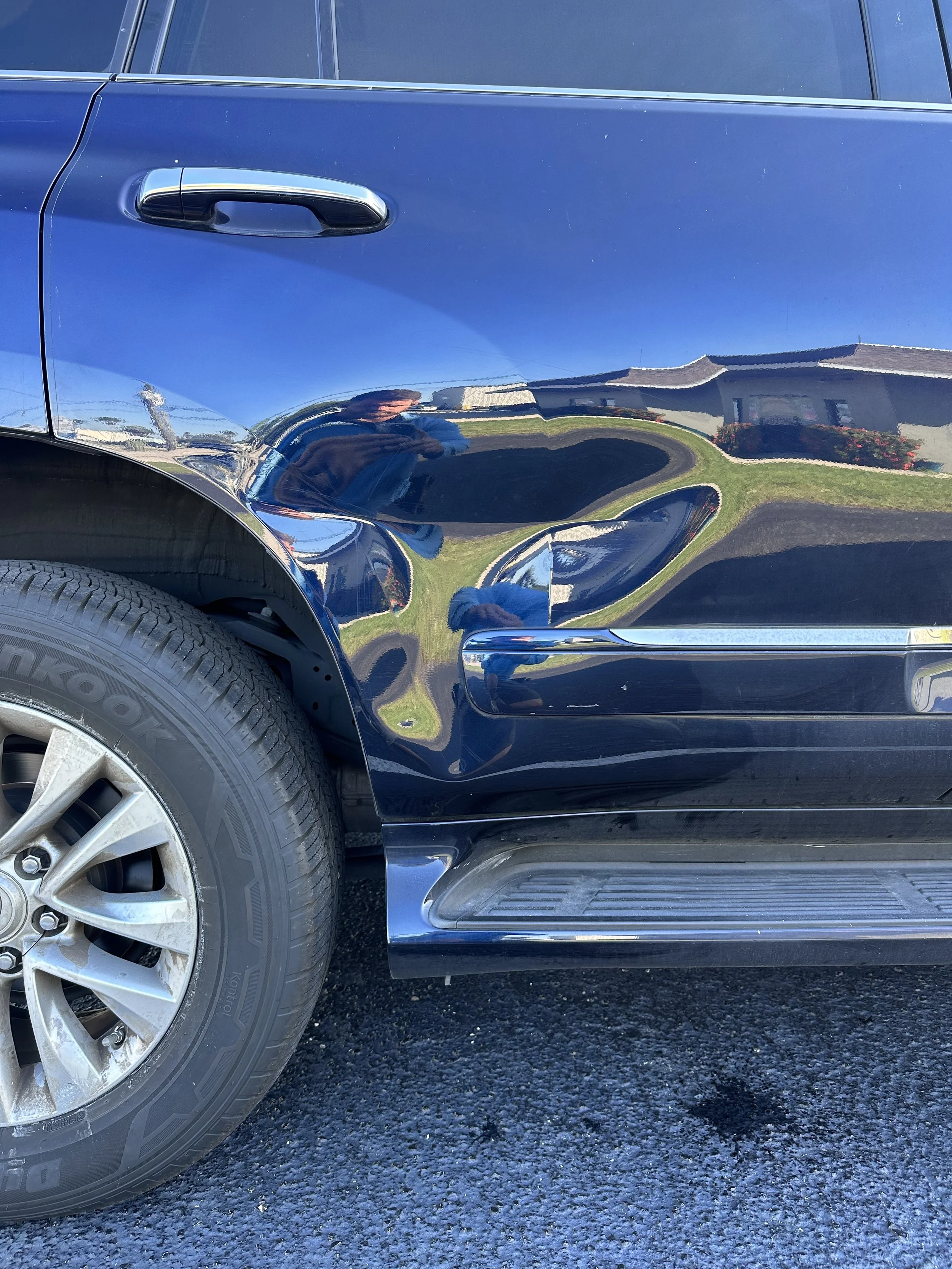 large dent on passenger rear door of customers Lexus GX460 repairs by Bone Dent Repair  with paintless dent removal (Pdr) at shop location 3180 SE Dominica Terrace Stuart Fl 34997
