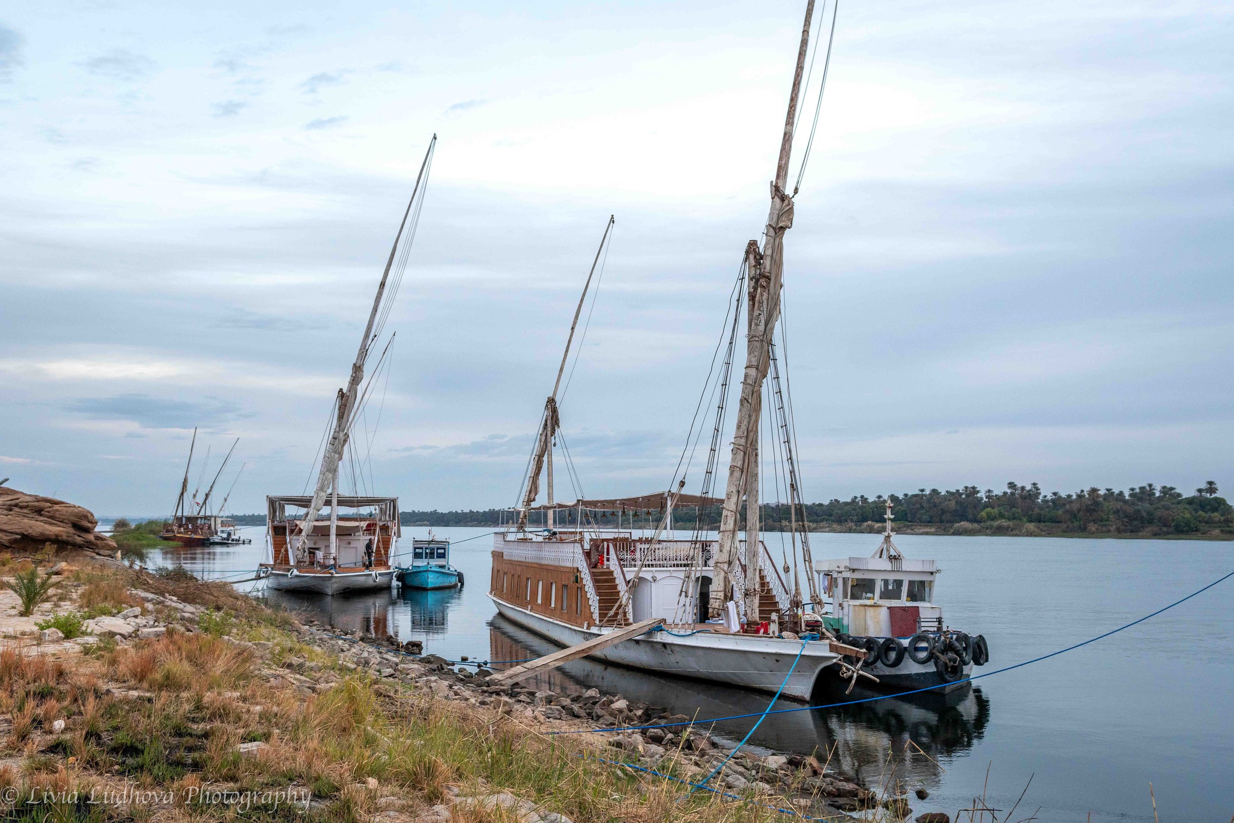 Several dahabiyas spent the night anchored at this location, turning the riverbank into a quiet floating village.