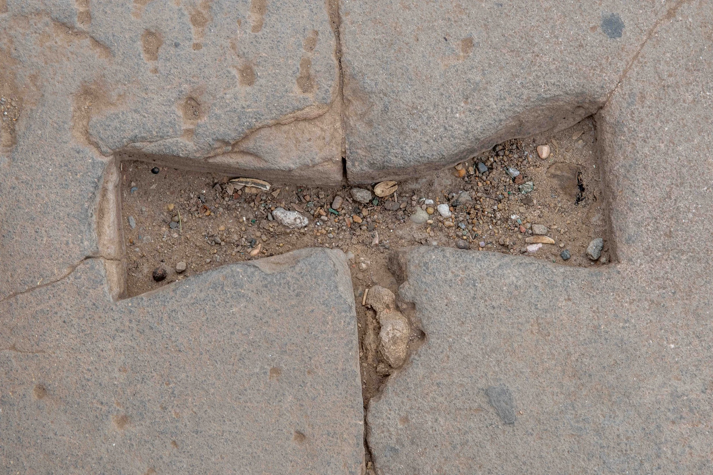 Dovetail clamp cut — Stone-cutting technique used to stabilize temple blocks; evidence of ancient construction methods.
