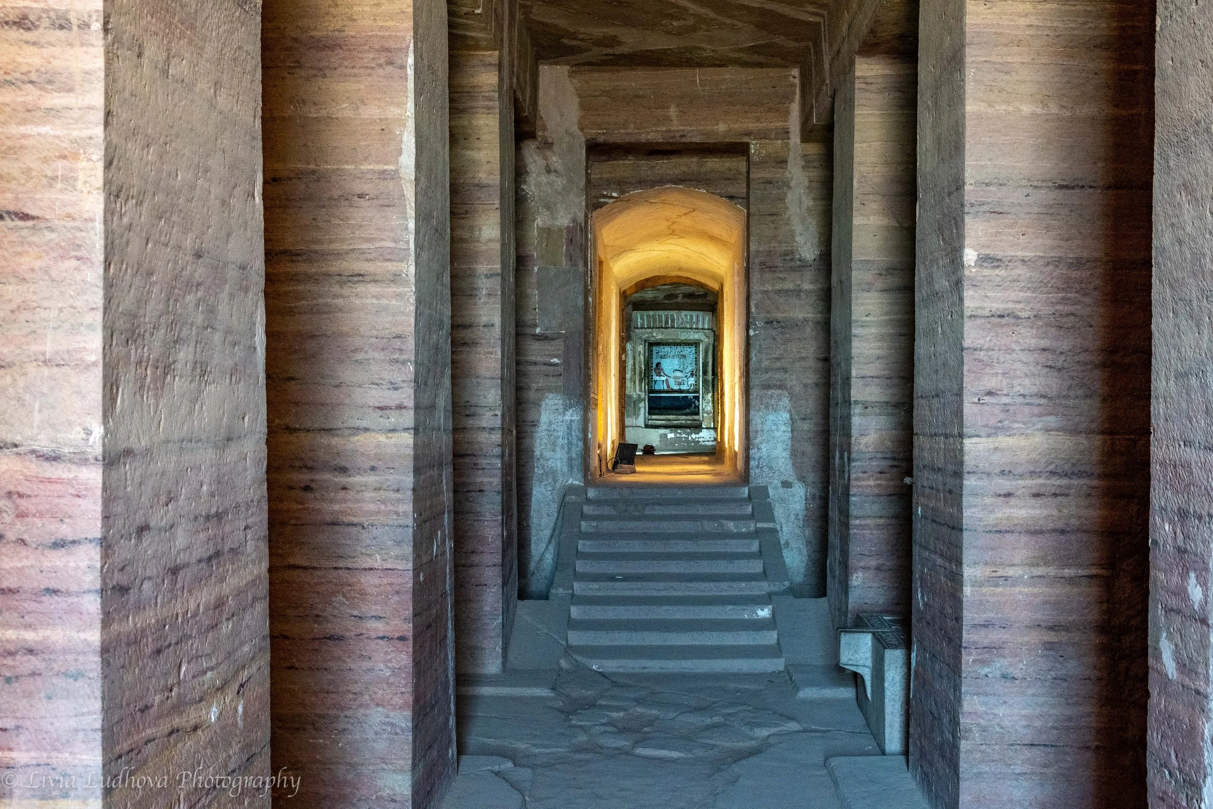 Precisely cut sandstone pillars and sharply defined edges in the tomb of Sarenput II, revealing the exceptional craftsmanship of Middle Kingdom stonework and the careful alignment of the passage leading toward the inner chambers.