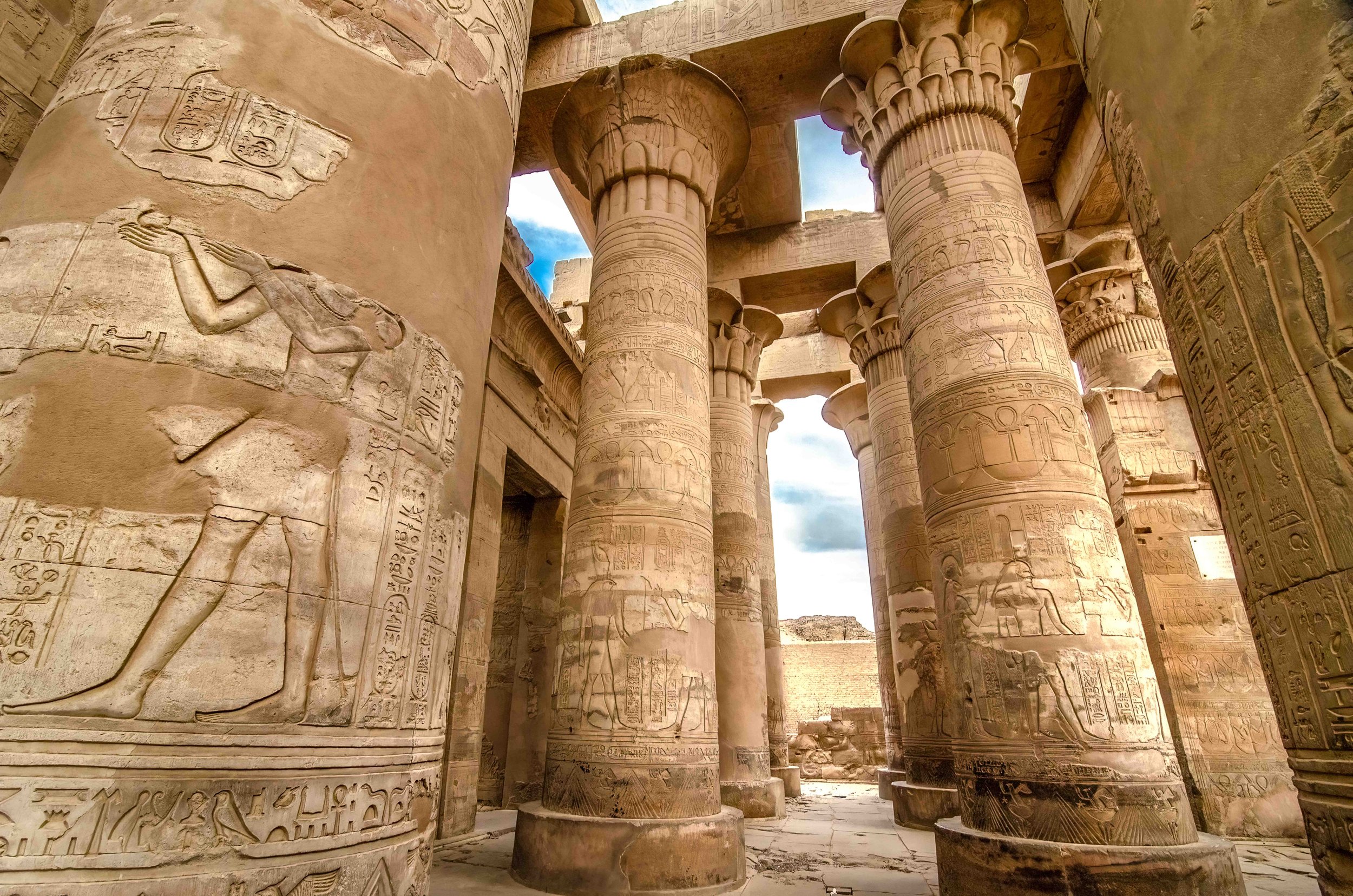 Hypostyle columns — Palm and floral capitals referencing fertility and the Nile environment.