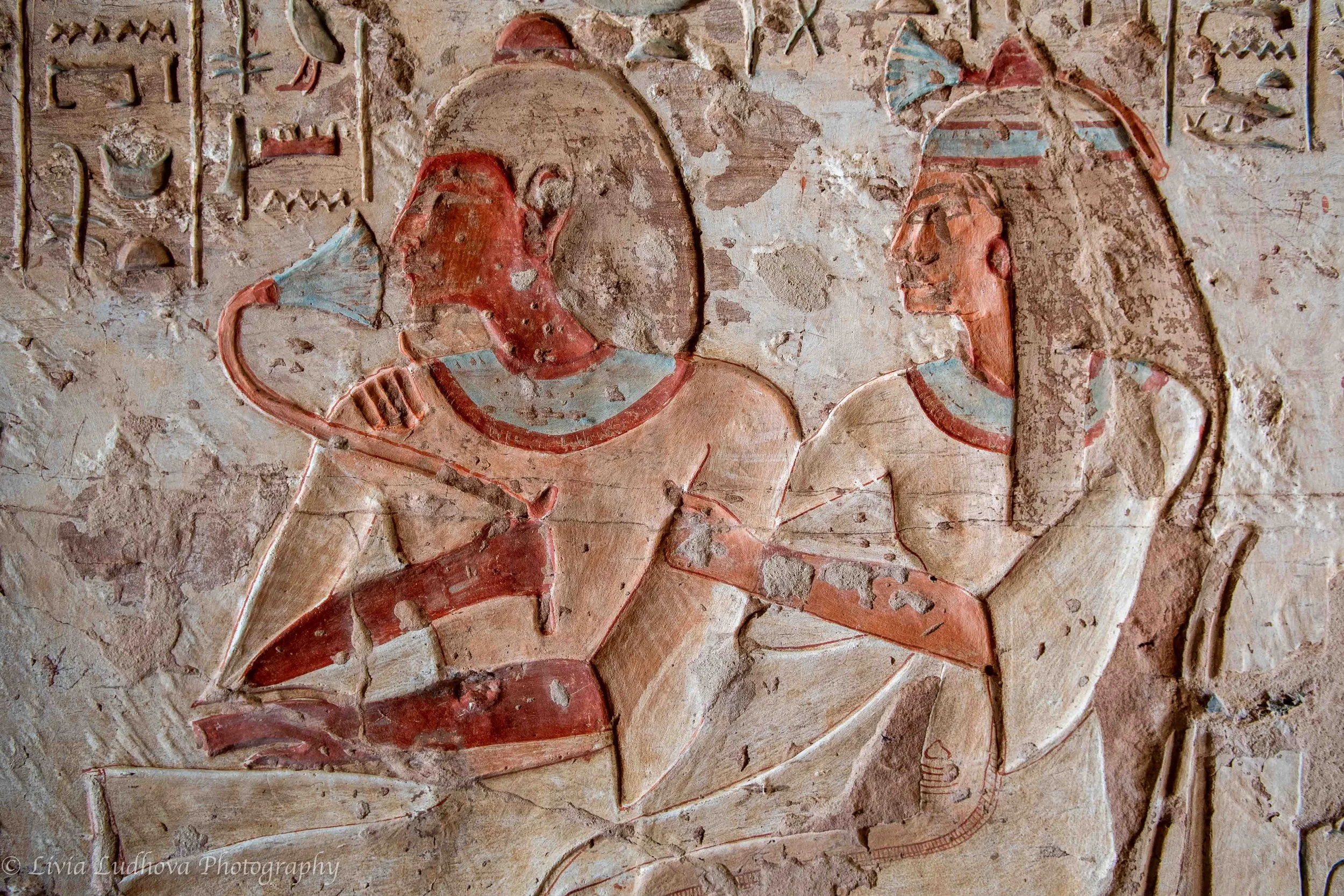 Couple in intimate ritual gesture,  depiction of familial presence.