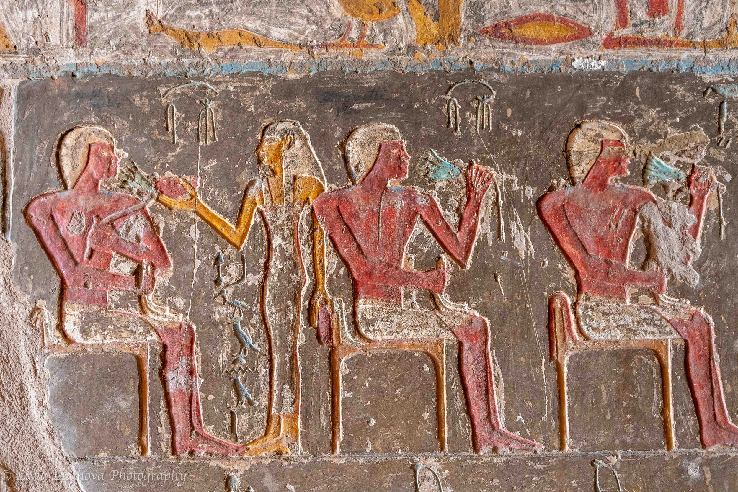 Seated figures in ritual context, wall relief, El Kab (Nekheb), early 18th Dynasty — provincial elite tomb decoration reflecting cult participation and status.