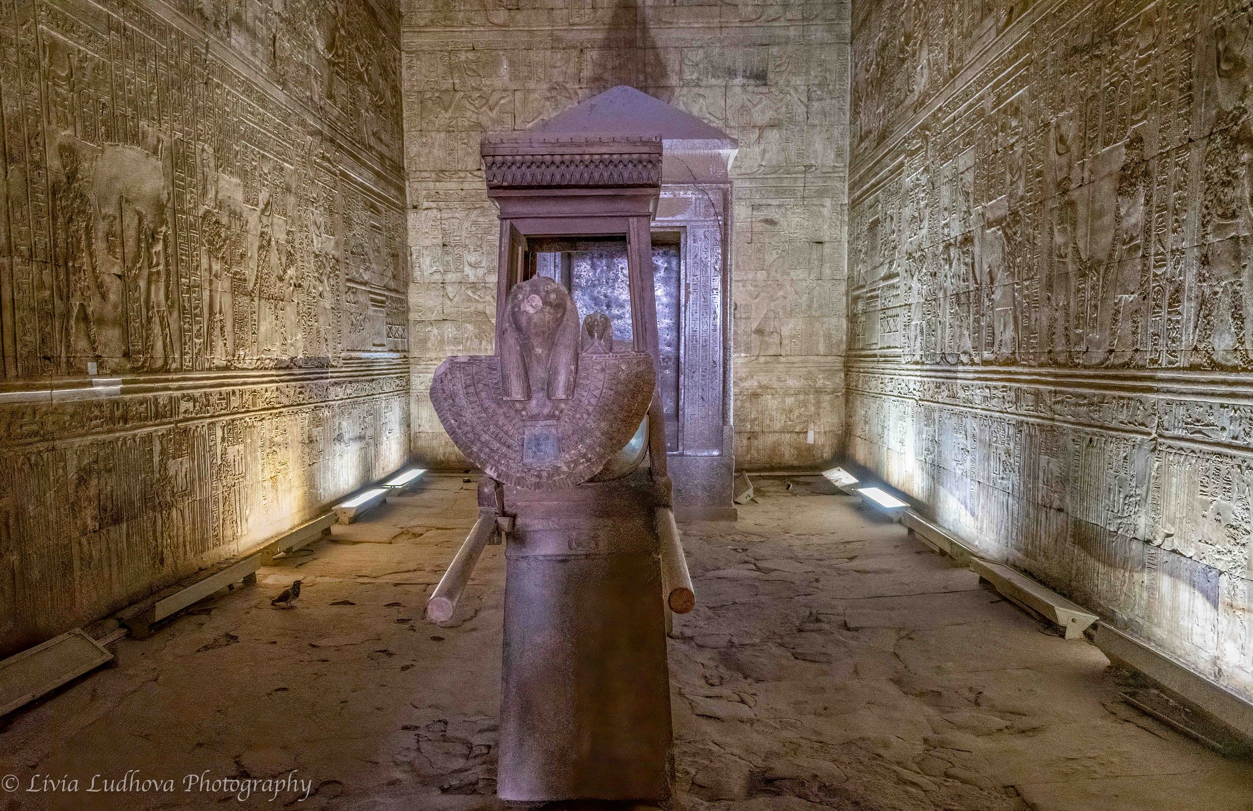 At the core of the sanctuary at Edfu, the granite shrine and falcon statue of Horus stand on the temple’s central axis, symbolizing the innermost sacred space where the god’s presence was believed to dwell.