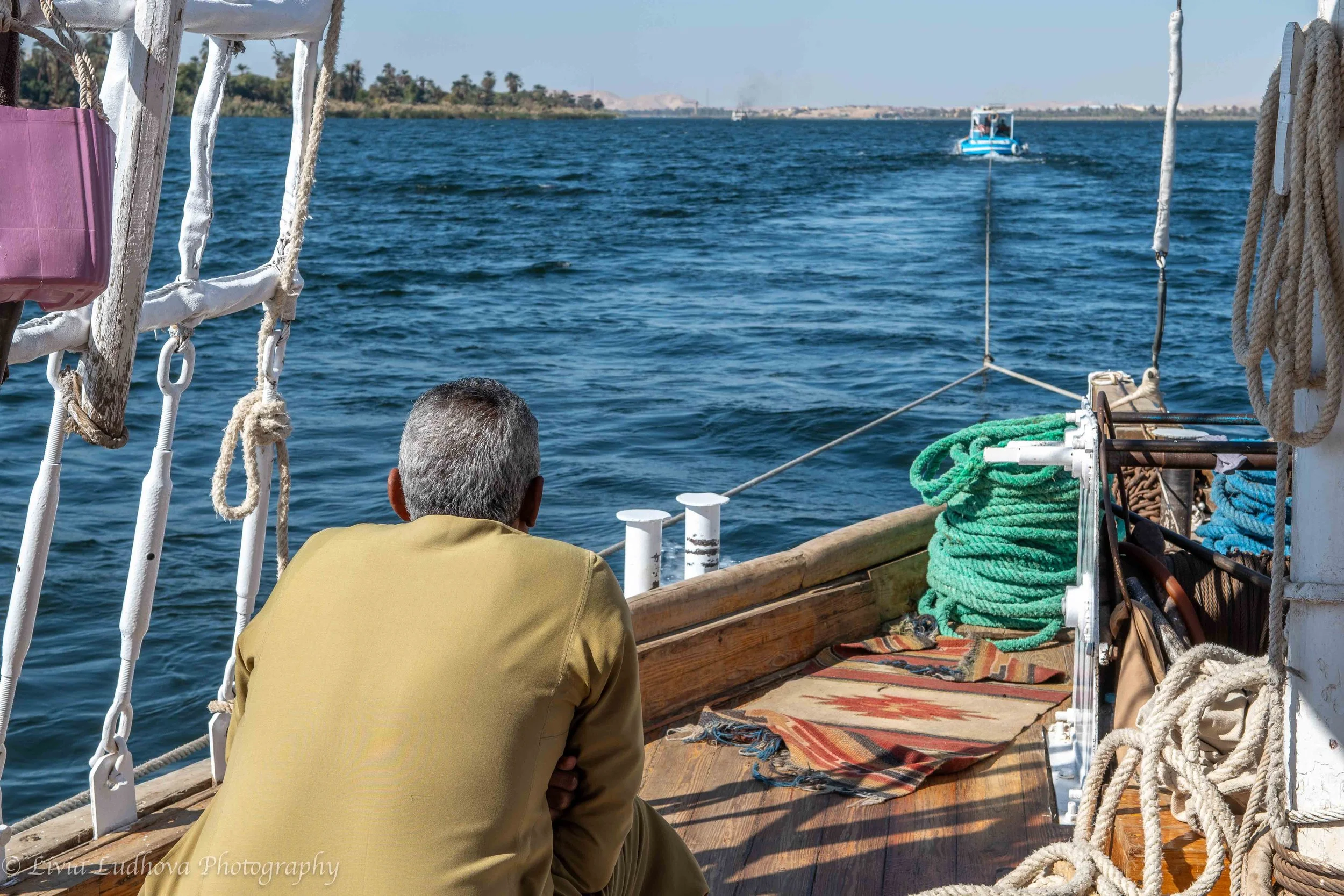 Captain resting on deck — quiet intervals between navigation tasks.