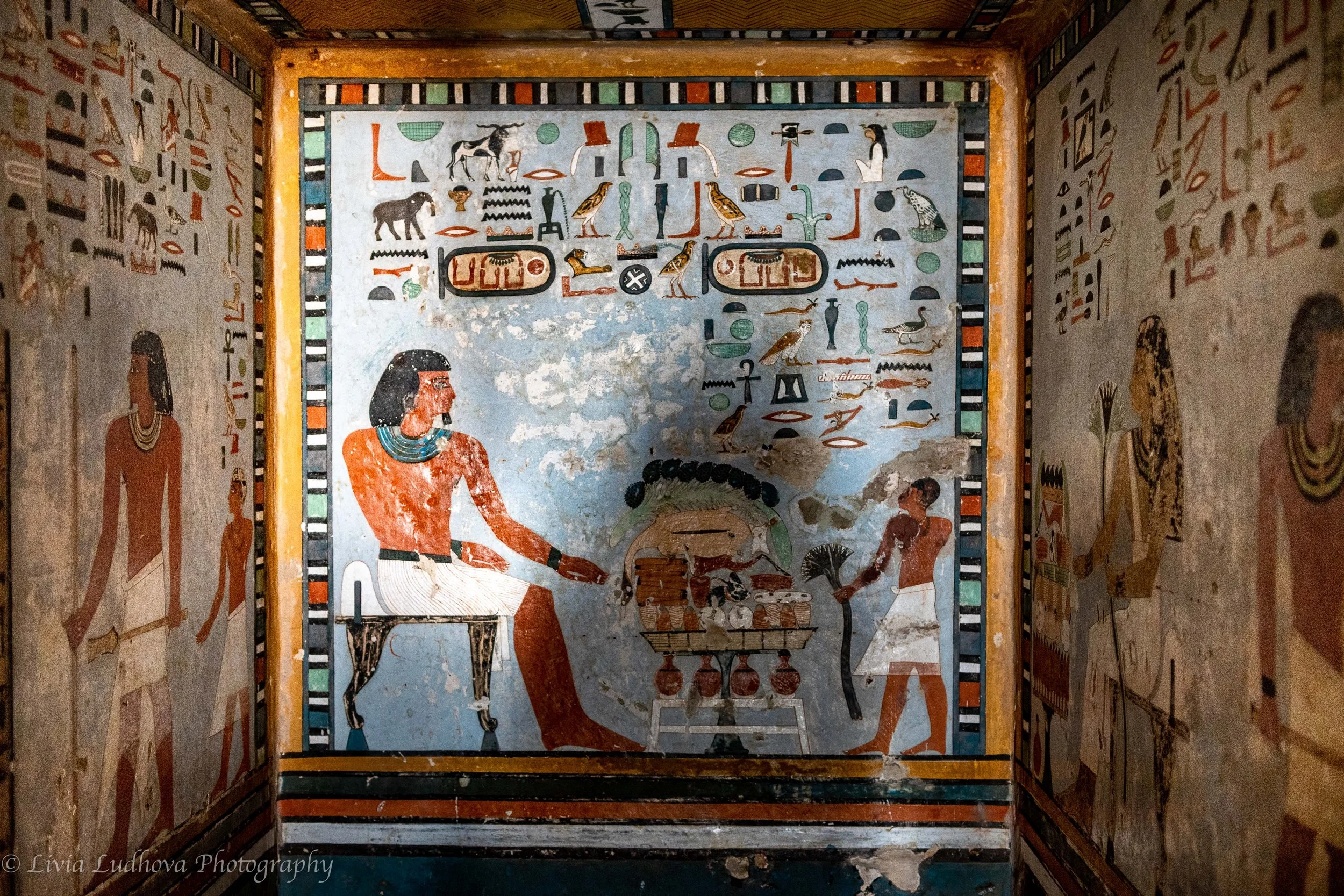 Offering scene in the tomb of Sarenput II, showing the tomb owner seated before an offering table, surrounded by richly colored hieroglyphs that ensured eternal sustenance and remembrance in the afterlife.
