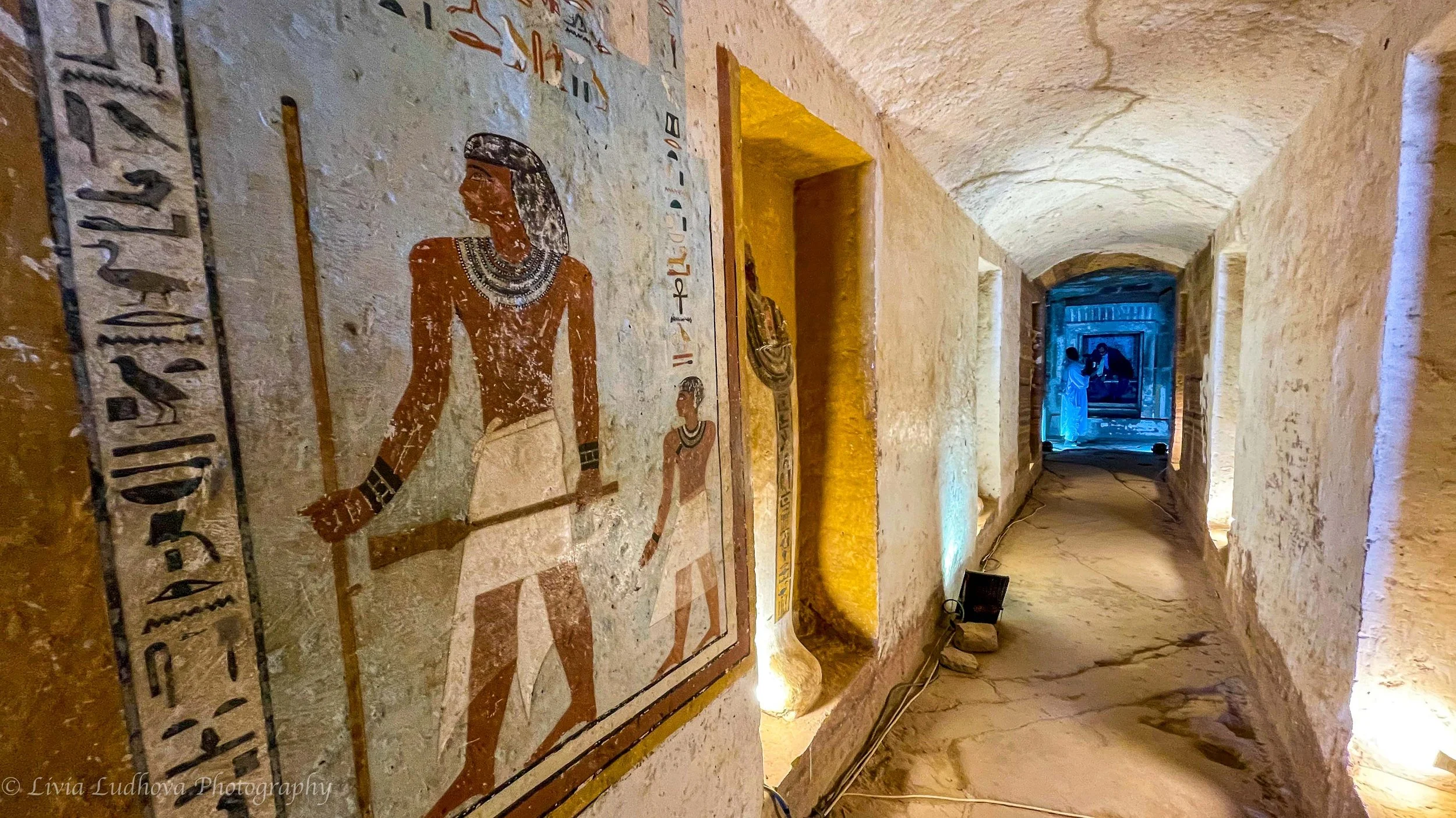 Painted corridor in the tomb of Sarenput II, where vividly preserved Middle Kingdom wall paintings and hieroglyphs accompany the long passage leading toward the burial chambers, guiding the deceased symbolically into the afterlife.