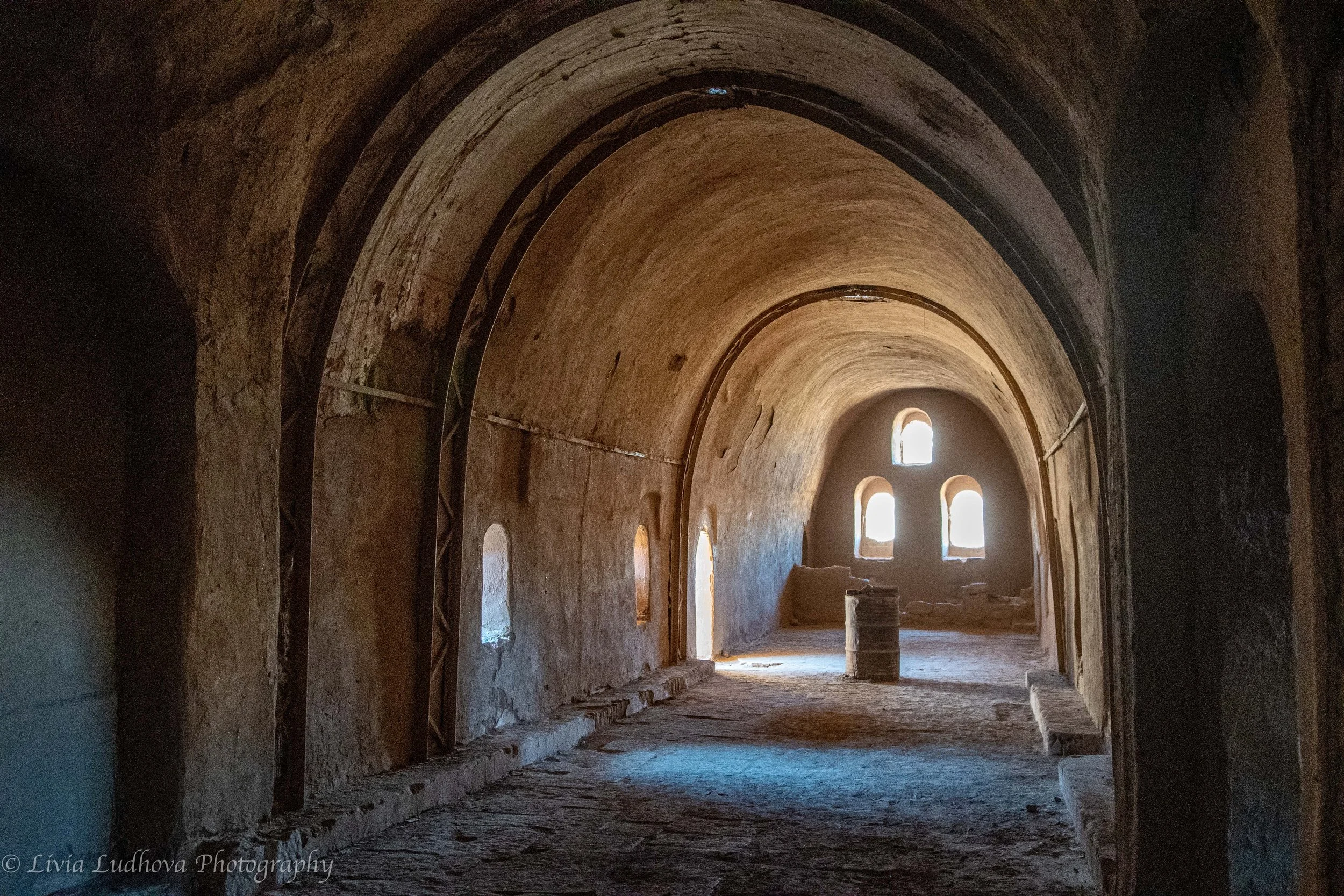Barrel-vaulted hall inside the Monastery of St. Simeon, once used for communal worship and daily life by a Coptic monastic community.