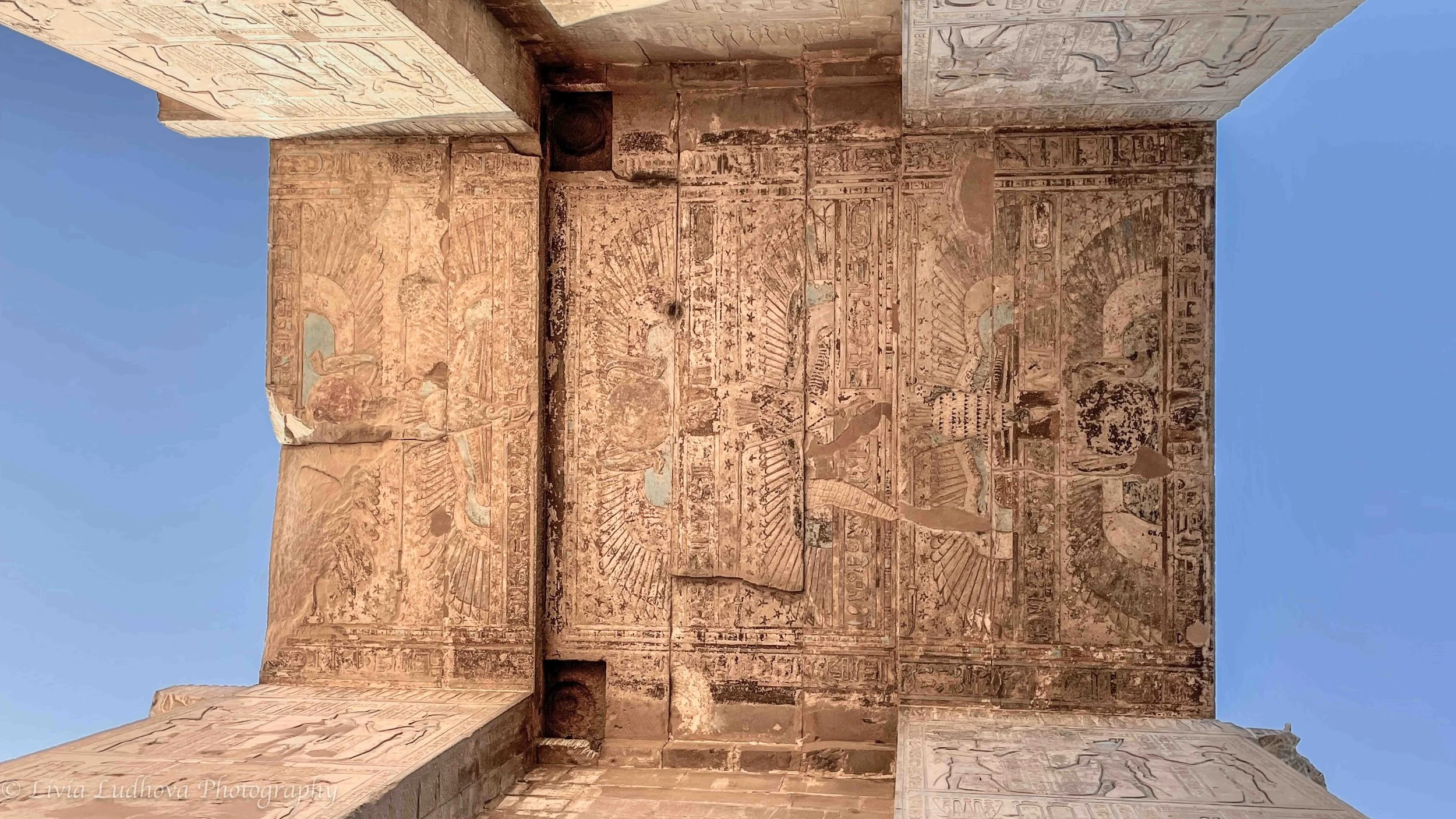 Stone “sky” above the pylon passage at the Temple of Horus, Edfu—carved with ritual texts and cosmic symbols that place everyone passing beneath it under the protection of the gods.