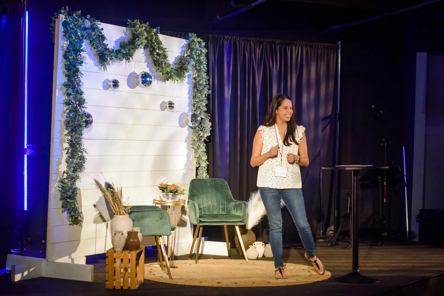 Christian speaker Jackie DaHora speaking on stage at a women's event