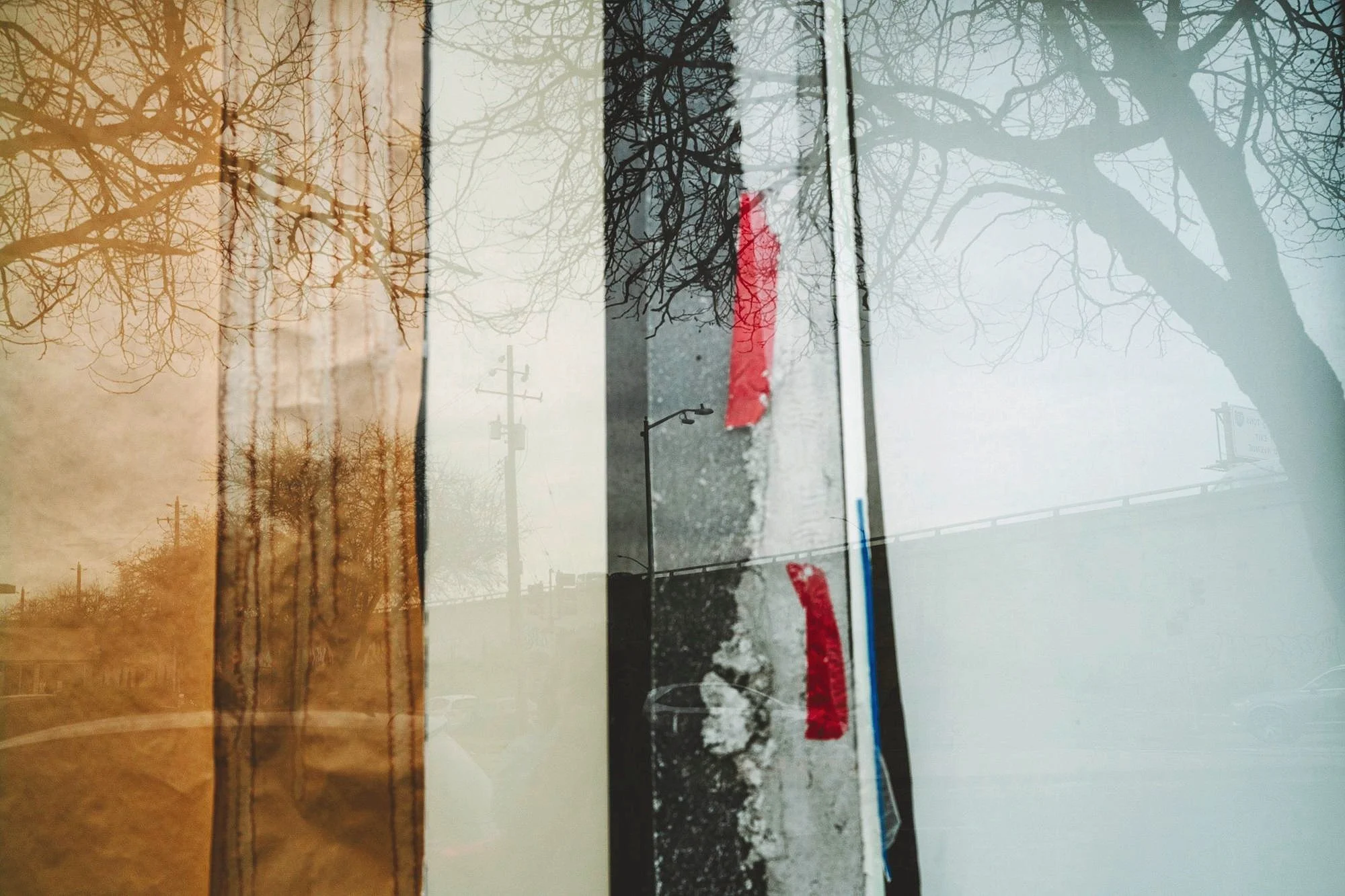 1. The MacArthur Freeway where it crosses San Pablo Avenue reflected in the papered windows of the historic California Hotel (3501 San Pablo Ave, Oakland)