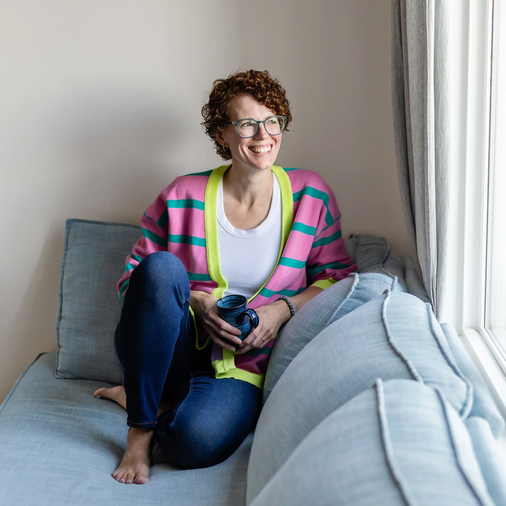 A mother painting at a desk surrounded by art supplies, reclaiming her creative identity while parenting a neurodivergent child