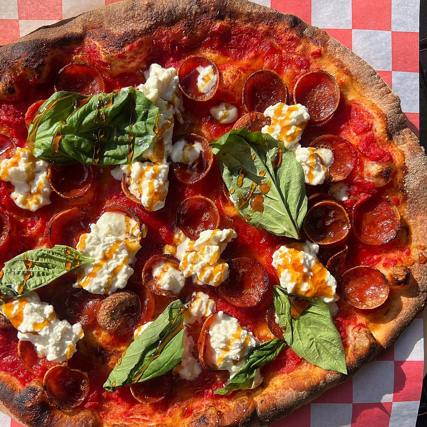 Although personally I like to chiffonade my basil, you have to admit that whole leaves of basil are pretty to look at.

This is my favorite pizza to make and by far the most popular pizza on our menu. Crushed tomato sauce, cupping Pepperoni, basil, s