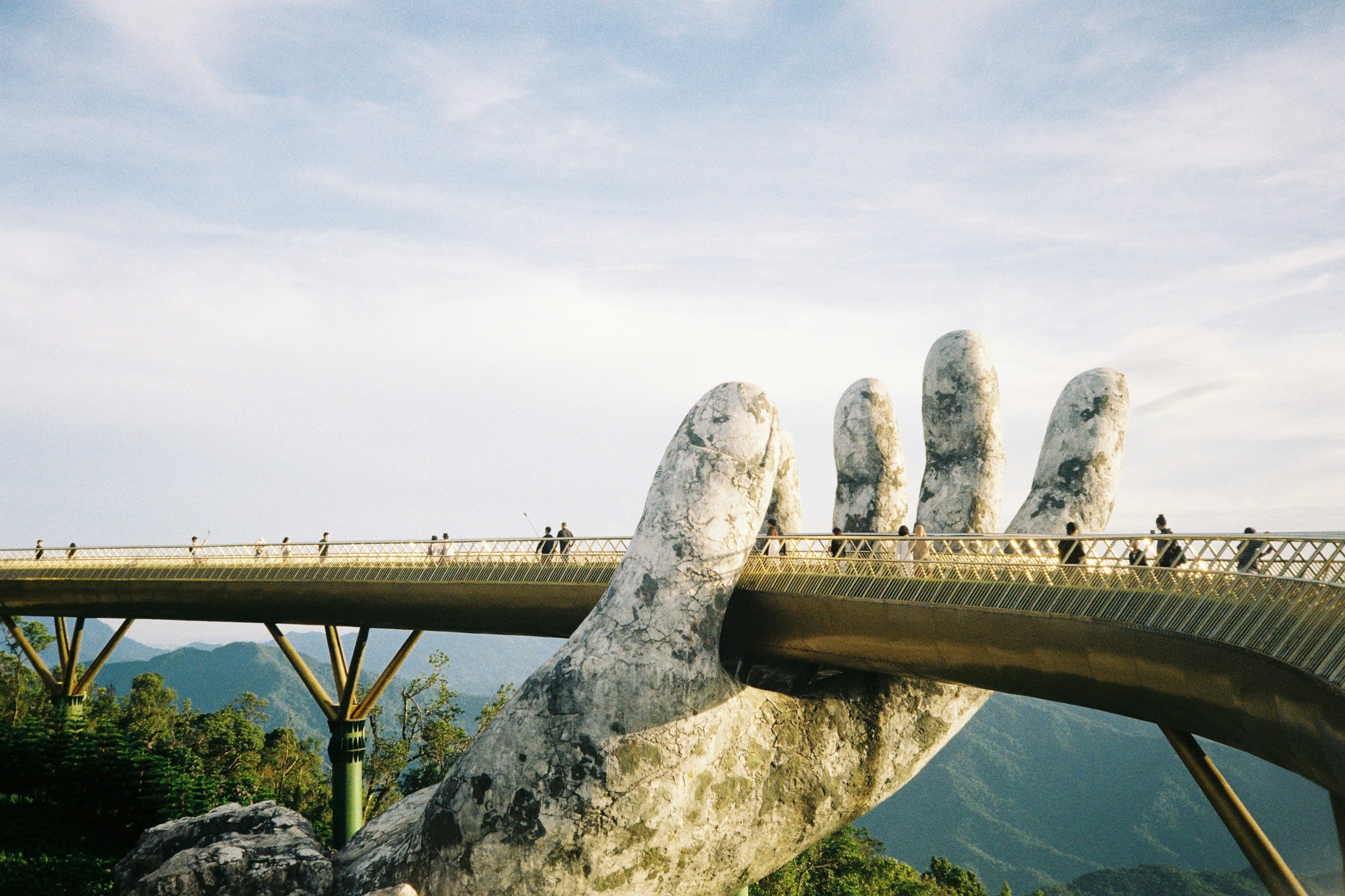 Golden Bridge with giant stone hands supporting the pedestrian walkway in Vietnam