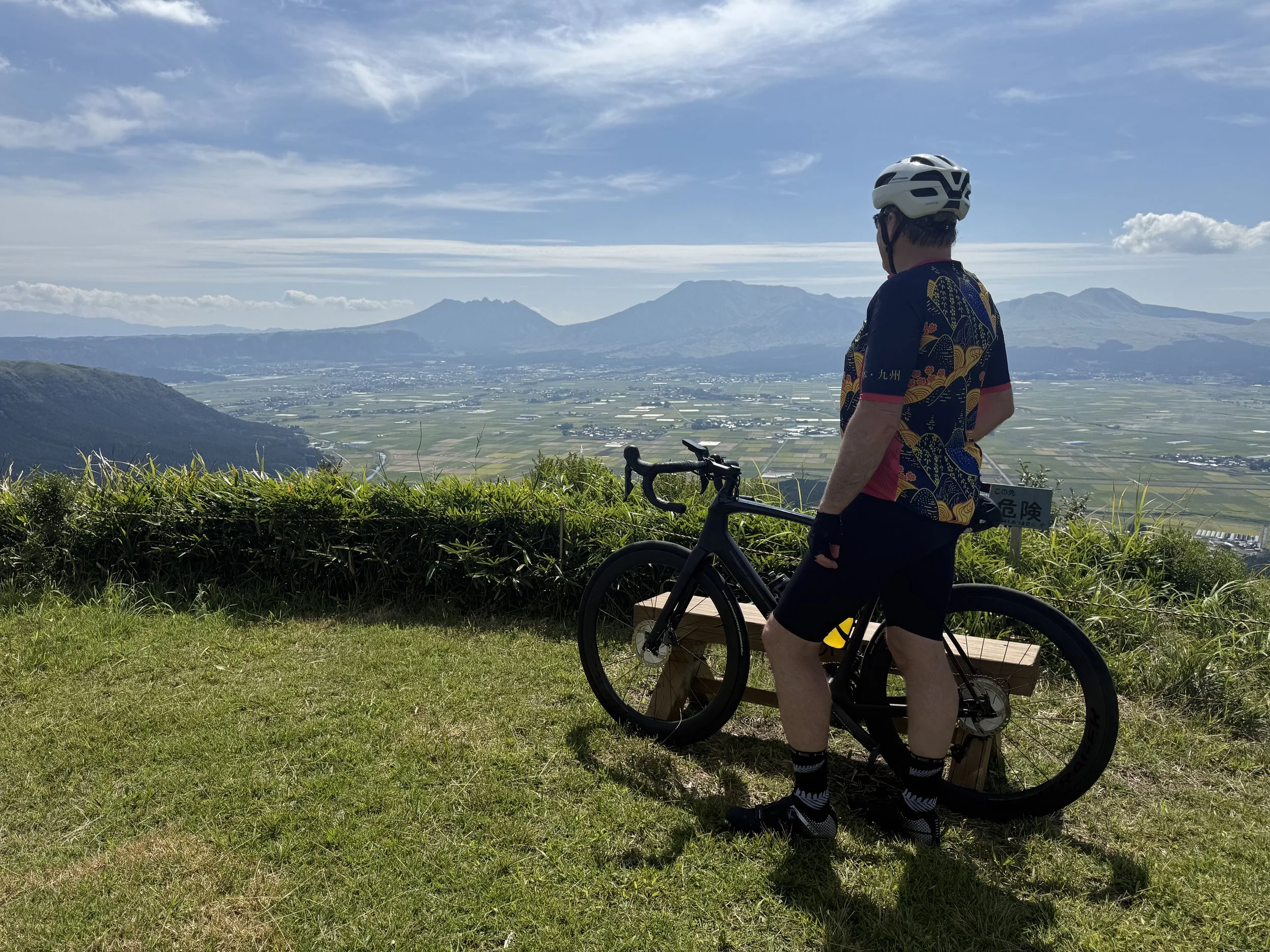 Cyclist looking out over Mt Aso in Kyushu