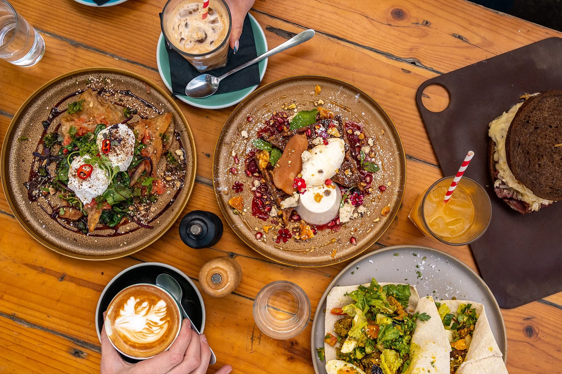 flatlay assortment of breakfast dishes with coffees