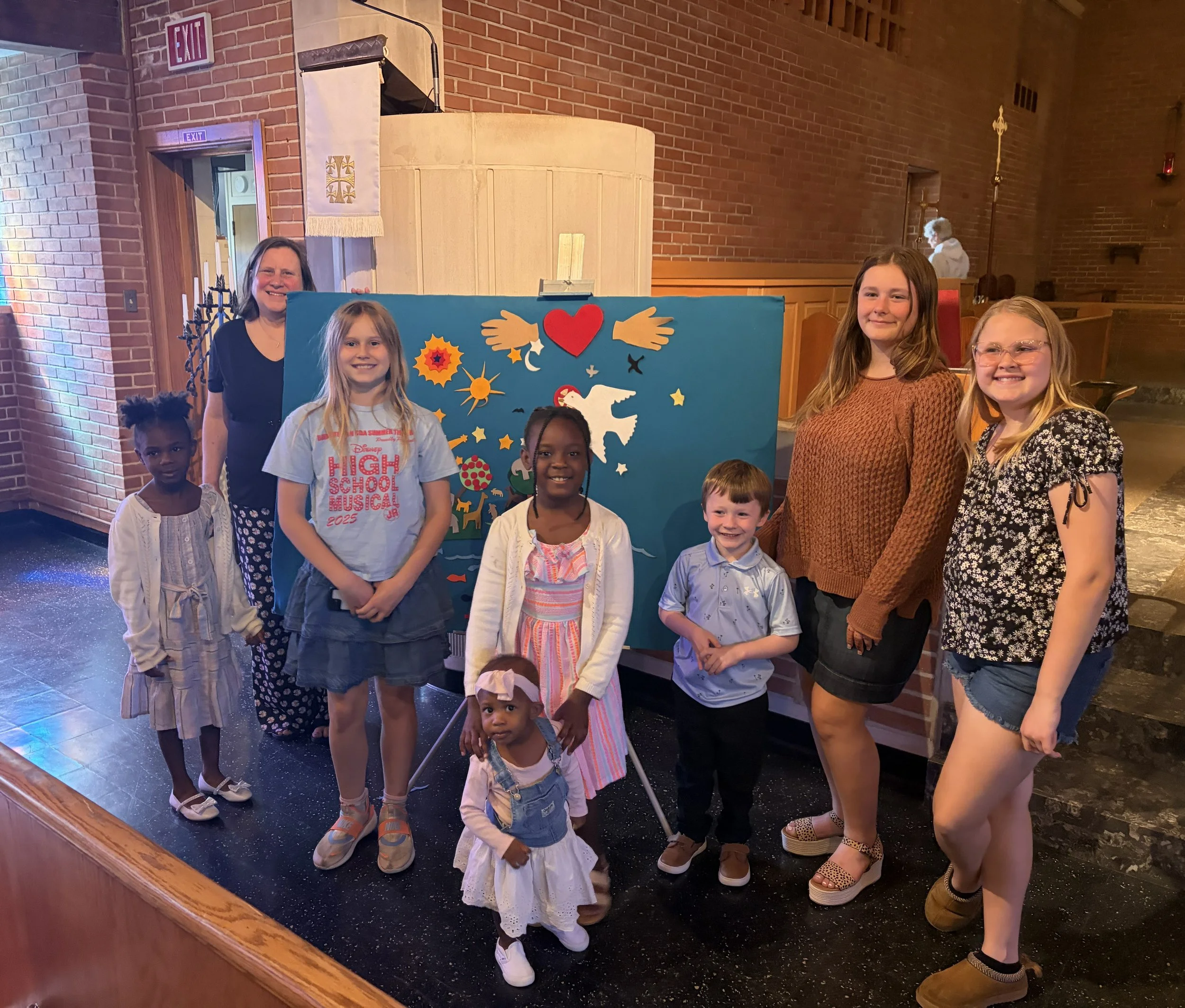 Miss Amy and Story Time attendees sharing the Creation Story during mass!