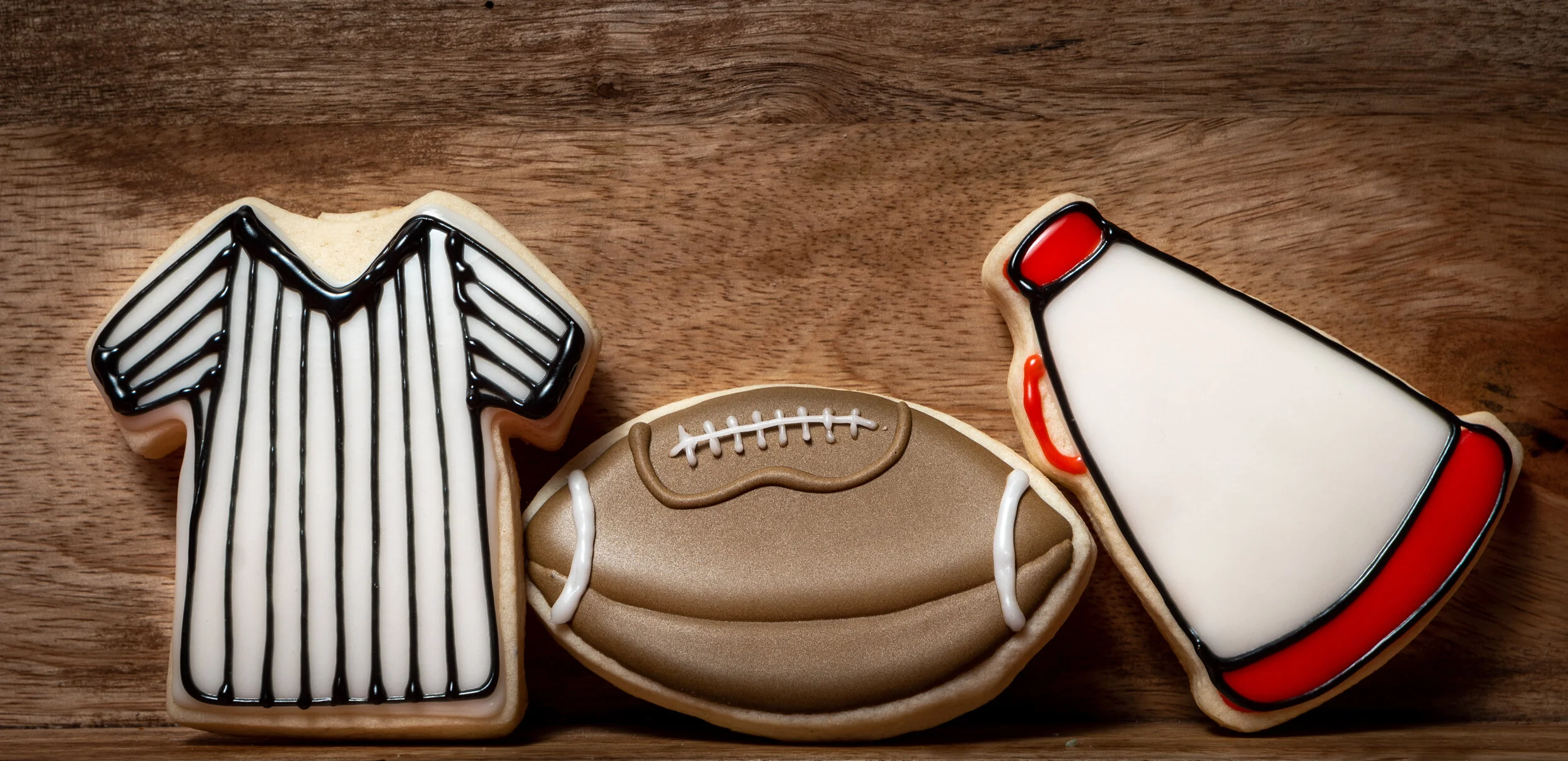 Football helmet, jersey, and water bottle decorated sugar cookies