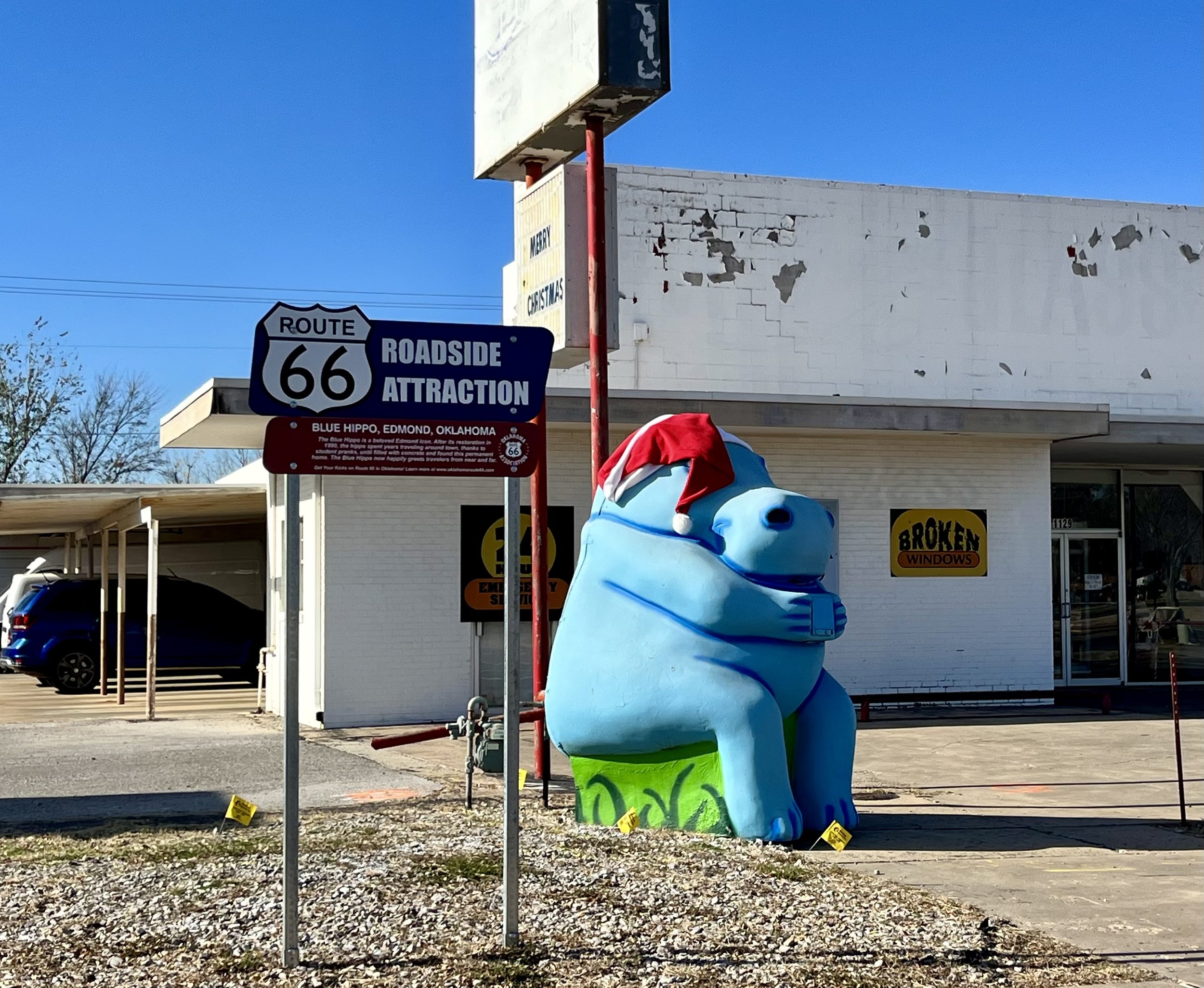 Blue hippo with roadside sign.jpg