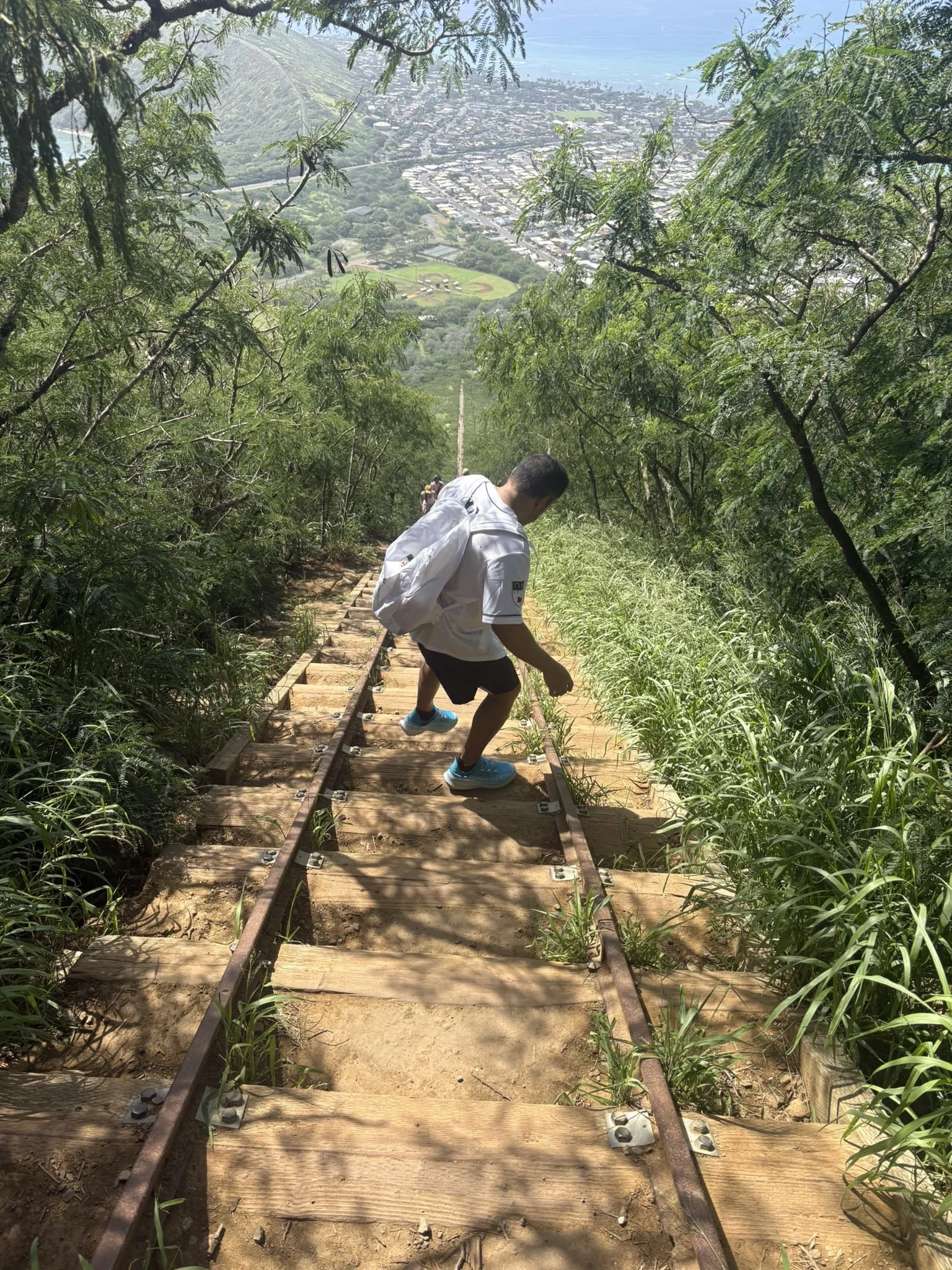 A man carefully walking down steep stairs, symbolizing managing anxiety and taking small steps through overwhelm