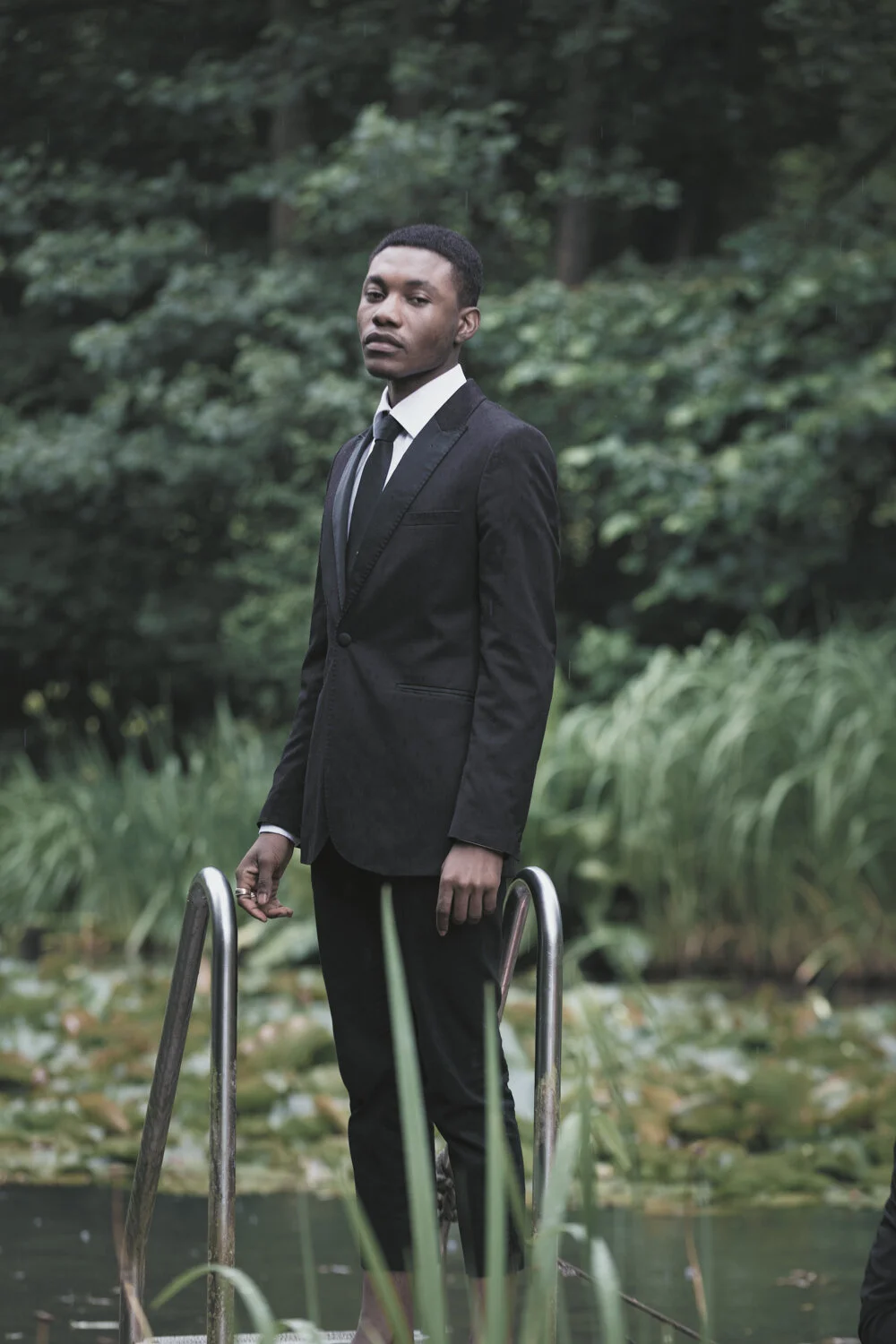 fashion-editorial-men-in-black-water-lily-pond-garden-3.jpg