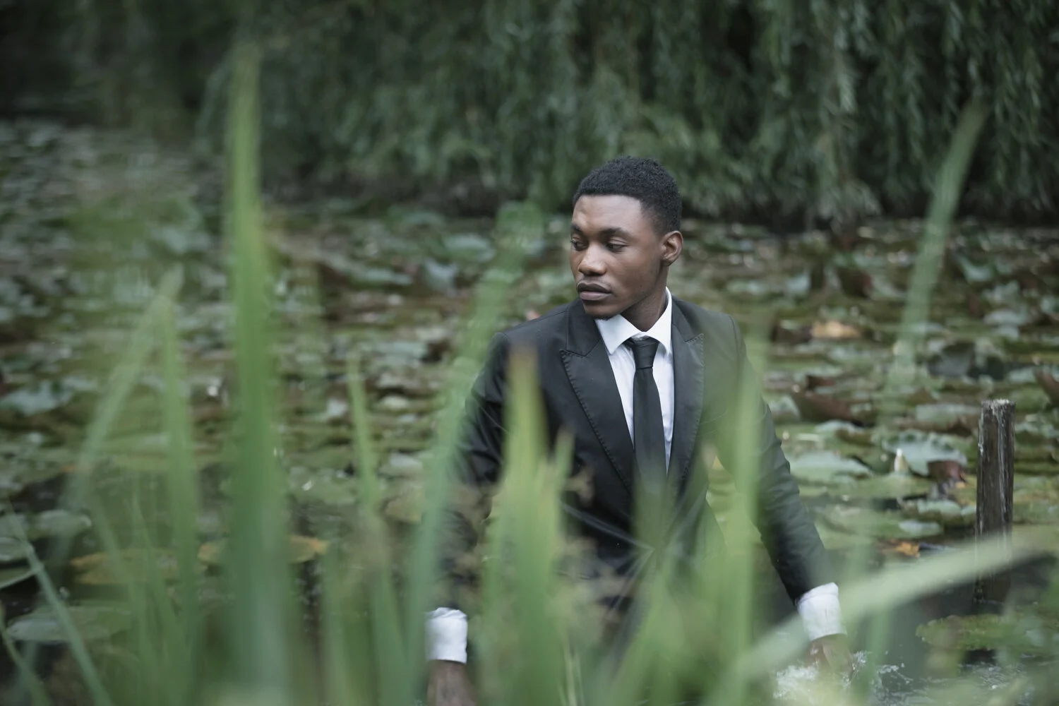 fashion-editorial-men-in-black-water-lily-pond-garden-14.jpg