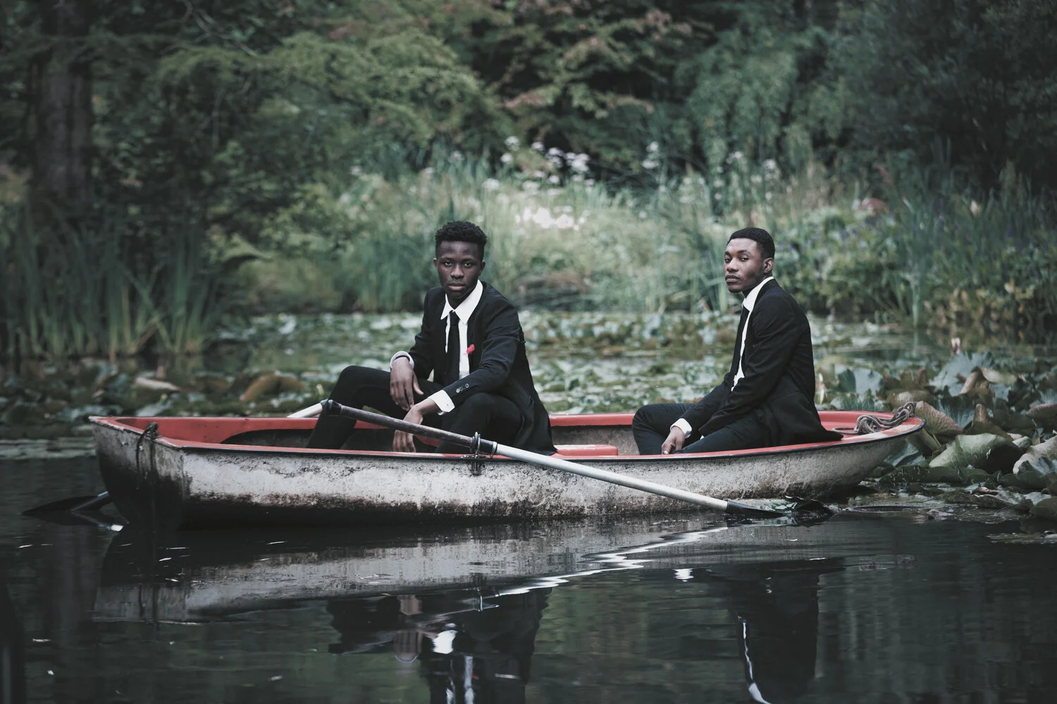 fashion-editorial-men-in-black-water-lily-pond-garden-6.jpg
