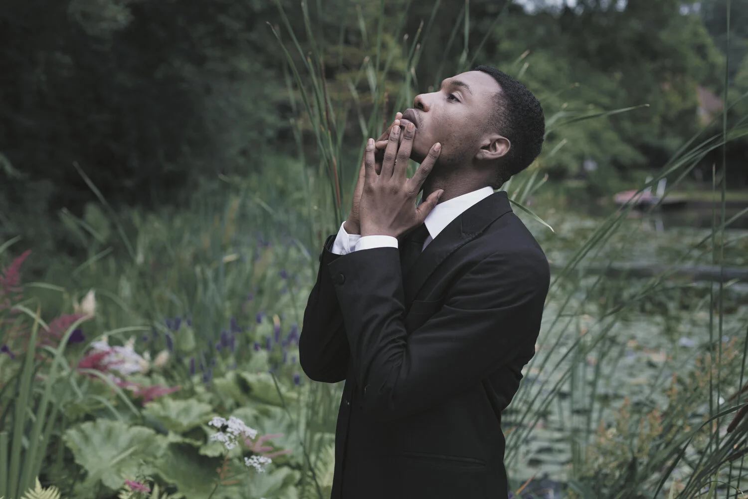 fashion-editorial-men-in-black-water-lily-pond-garden-2.jpg