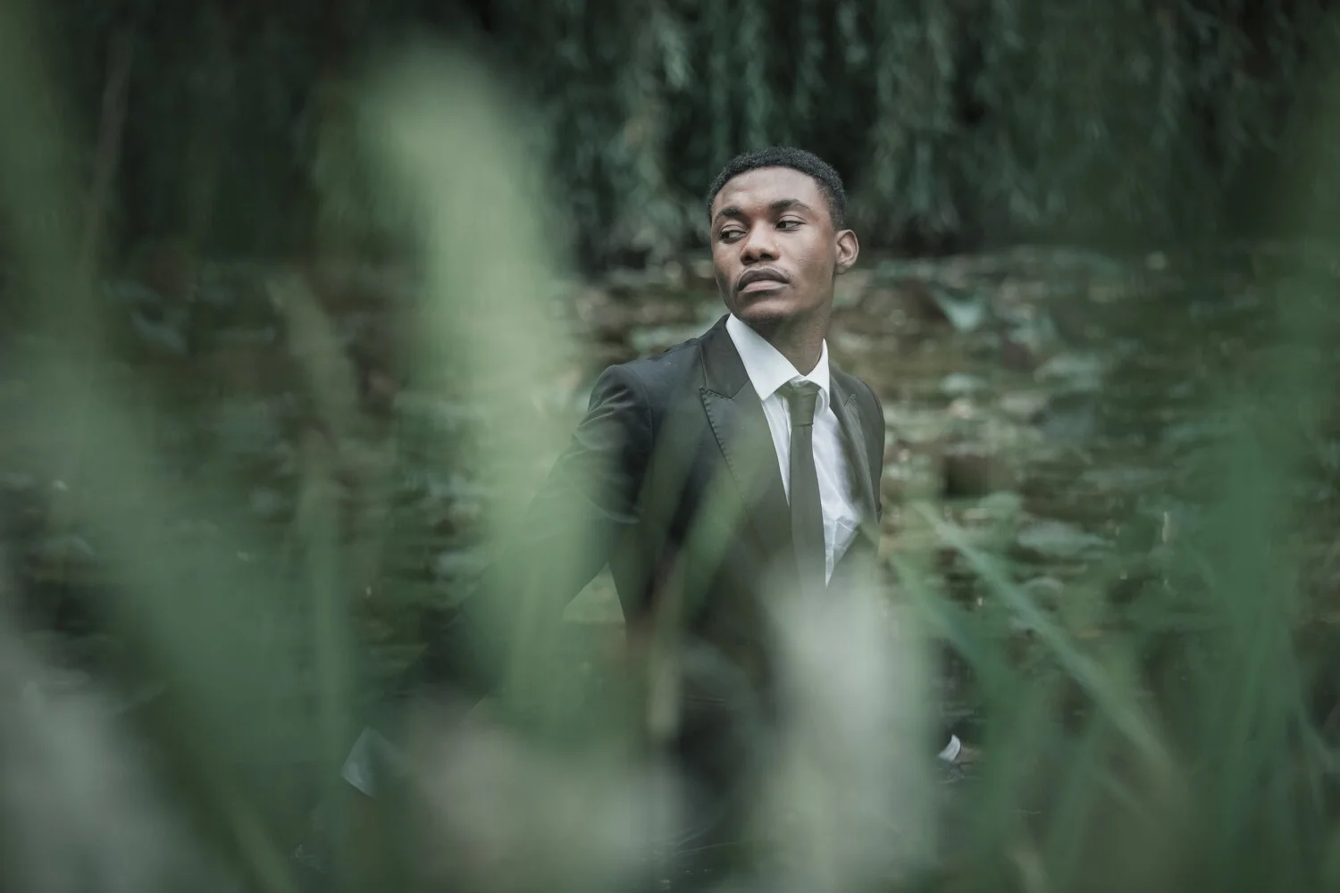 fashion-editorial-men-in-black-water-lily-pond-garden-16.jpg