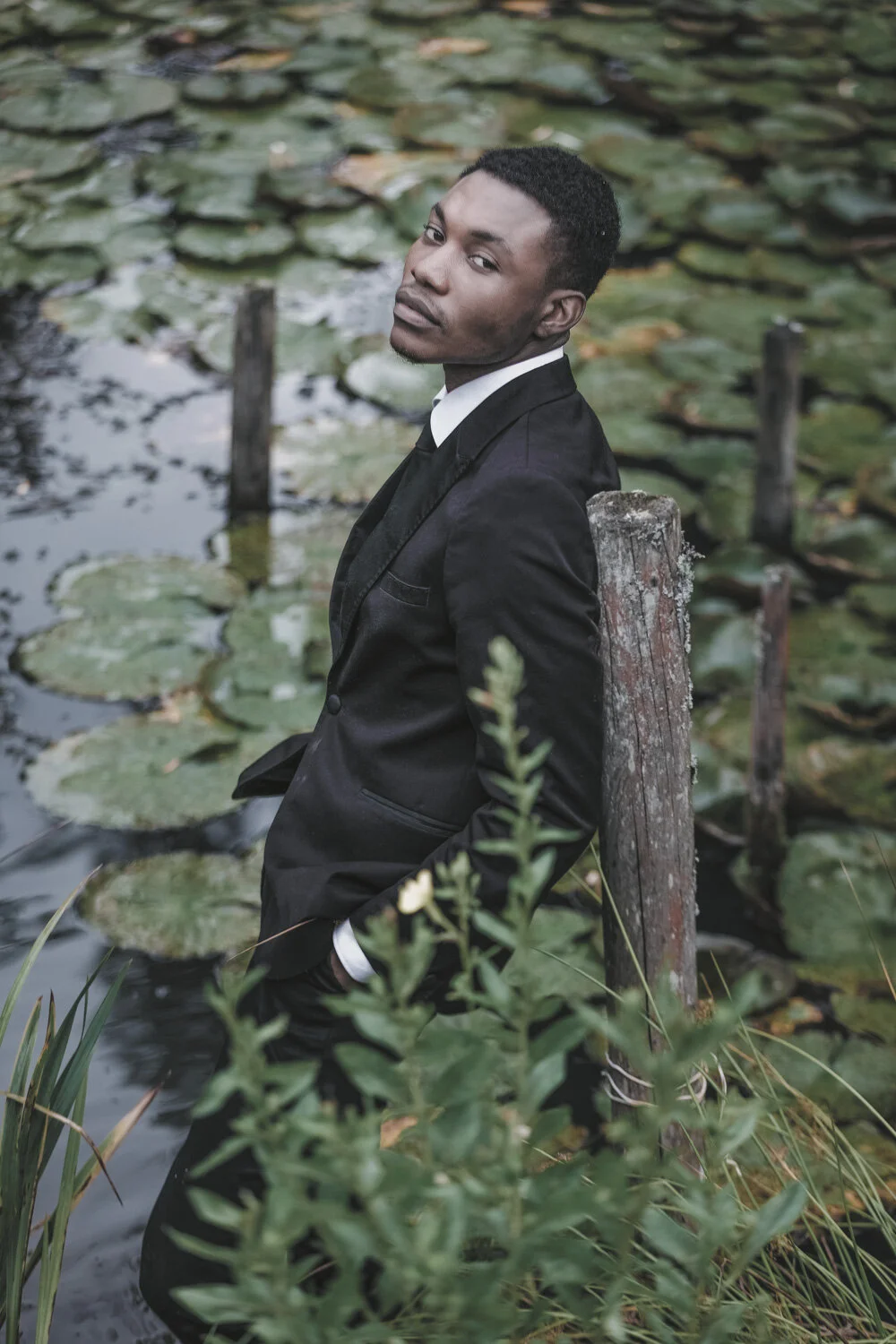 fashion-editorial-men-in-black-water-lily-pond-garden-10.jpg
