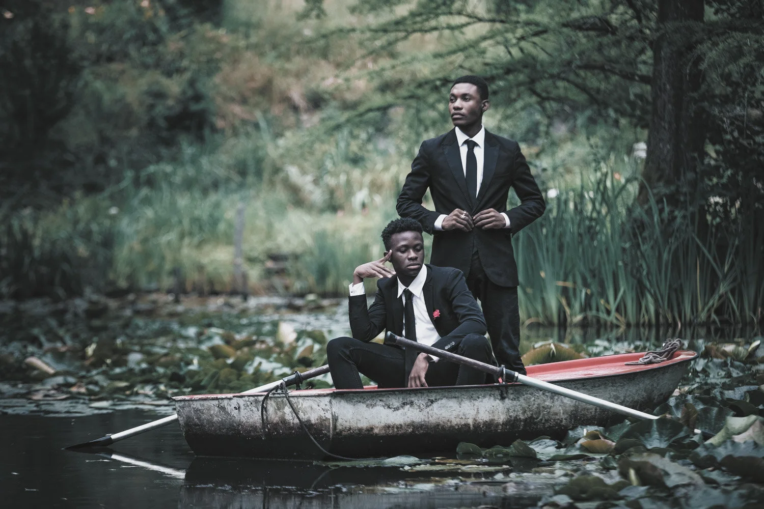 fashion-editorial-men-in-black-water-lily-pond-garden-9.jpg