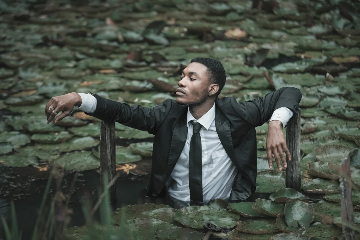 fashion-editorial-men-in-black-water-lily-pond-garden-13.jpg