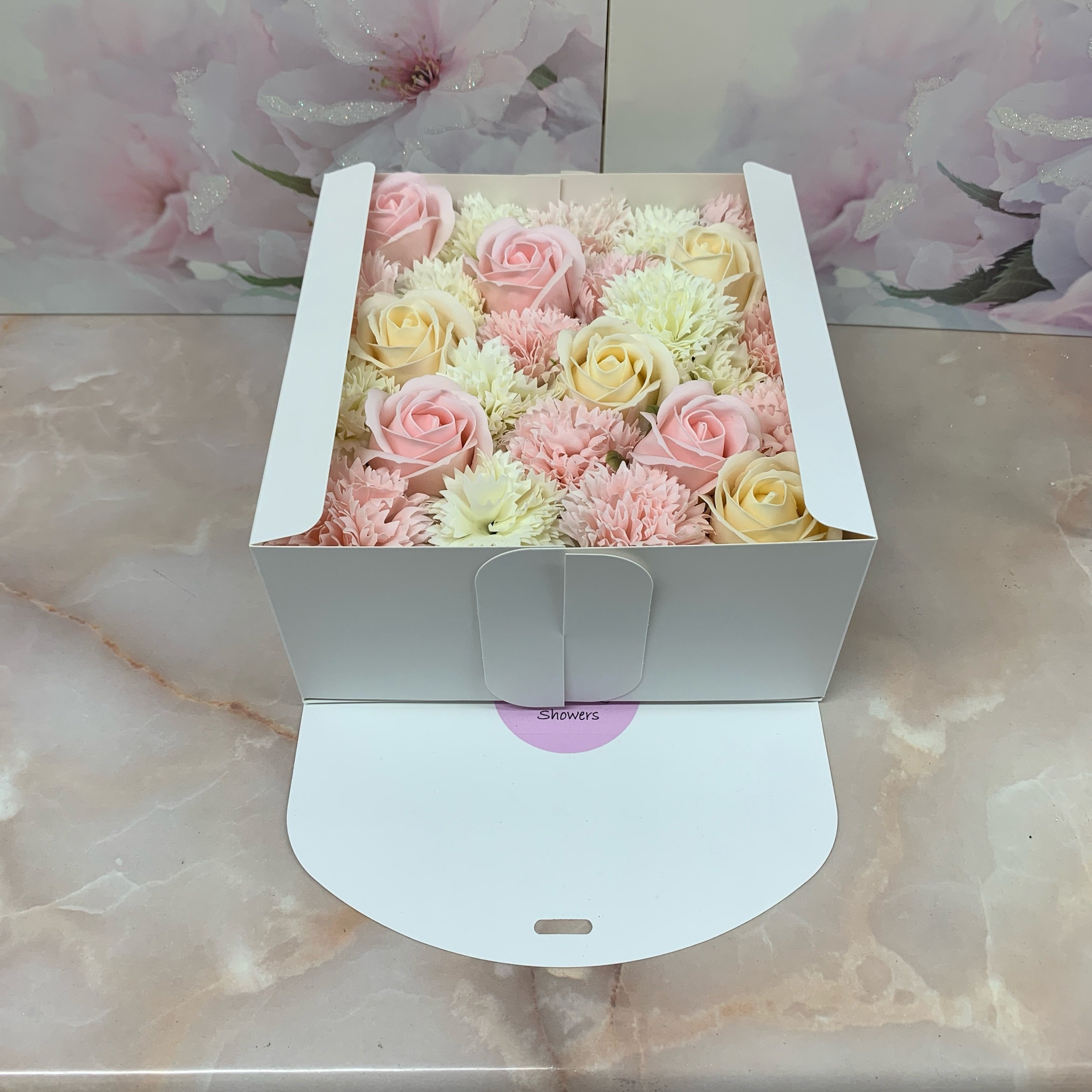 over 20 pink and cream scented soap rose and carnation flowers in a white ribboned gift box