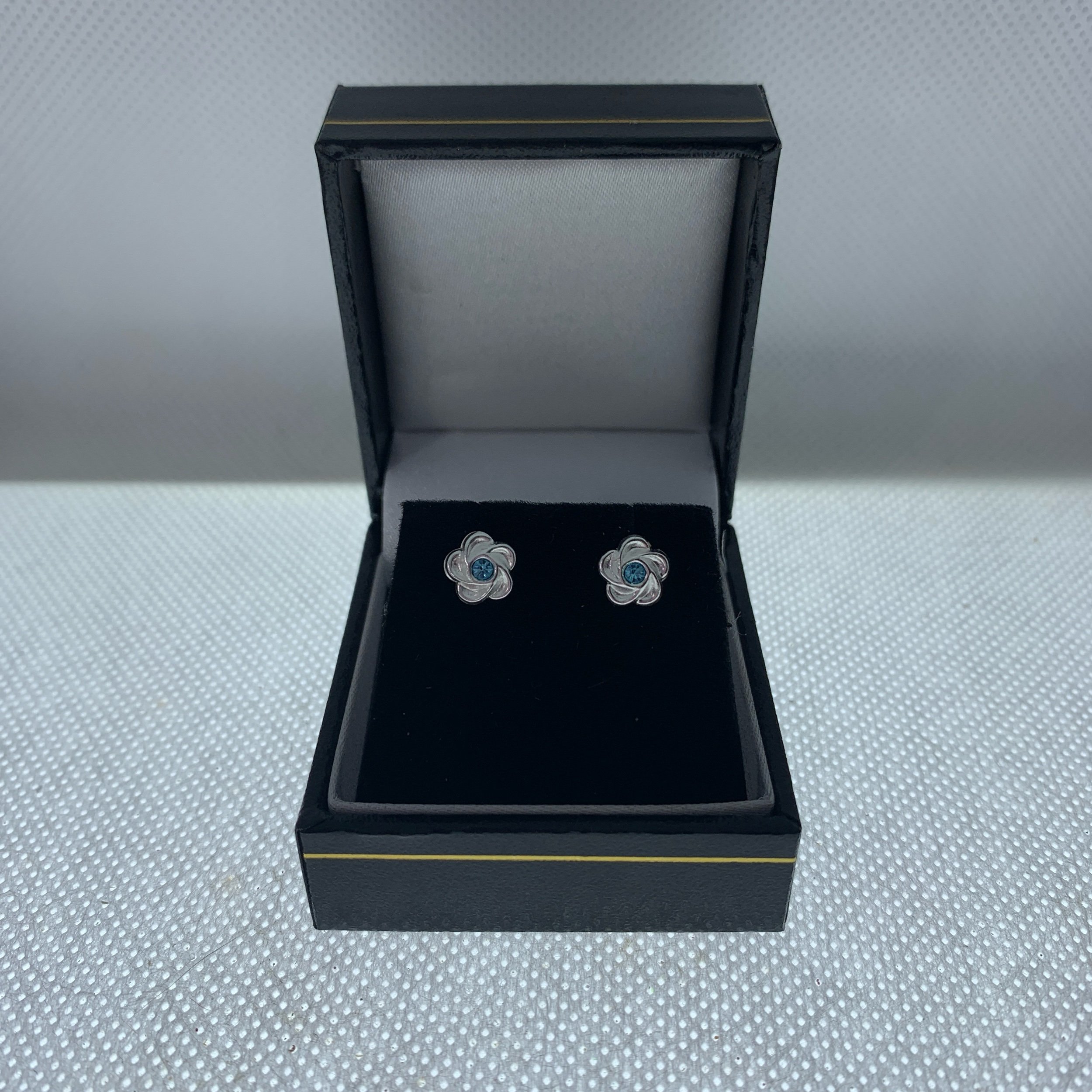 7mm sterling silver flower shape earrings with aqua crystal centre in black leatherette gift box