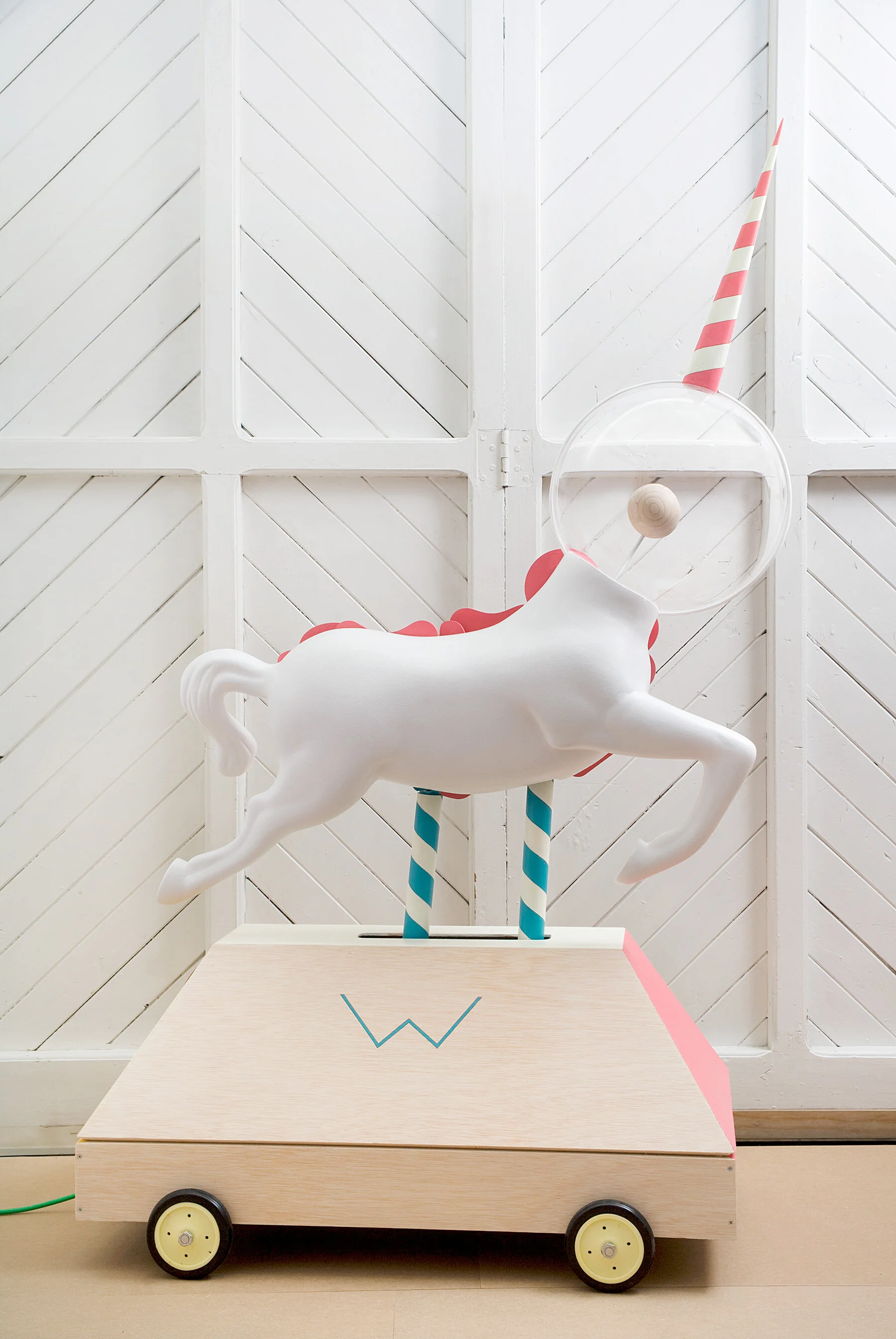  Reverse side view of the white-painted wooden mechanical unicorn sculpture by Brosmind.