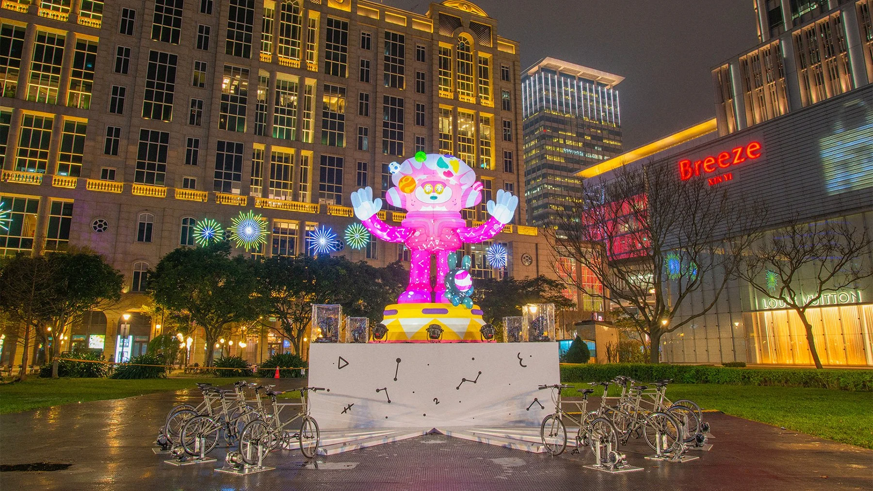 Illuminated Brosmind inflatable lantern at night, powered by interactive pedal bicycles on the base platform.