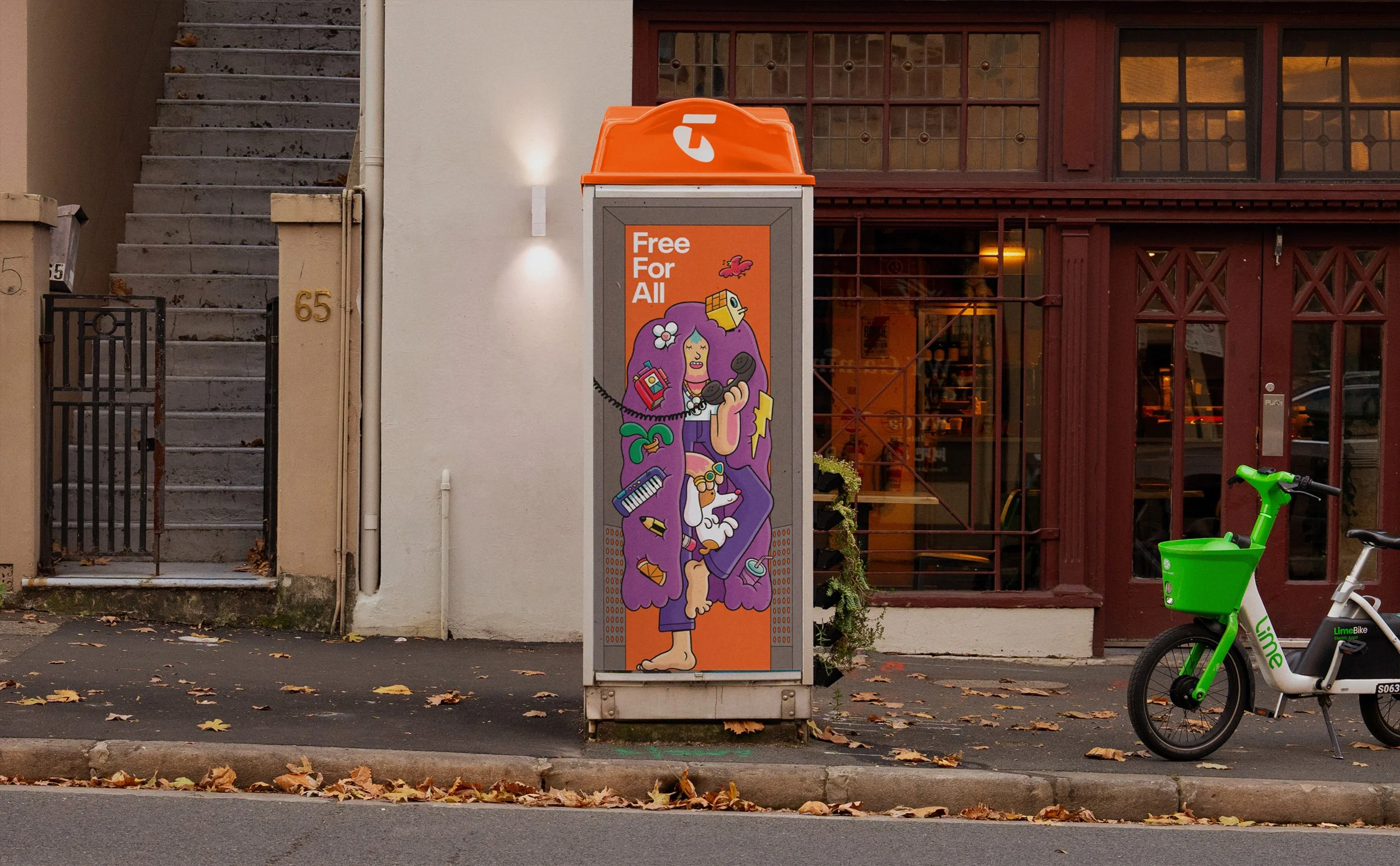 Street phone booth featuring Brosmind's character design of a girl with whimsical objects embedded in her hair for the Telstra Australia campaign.